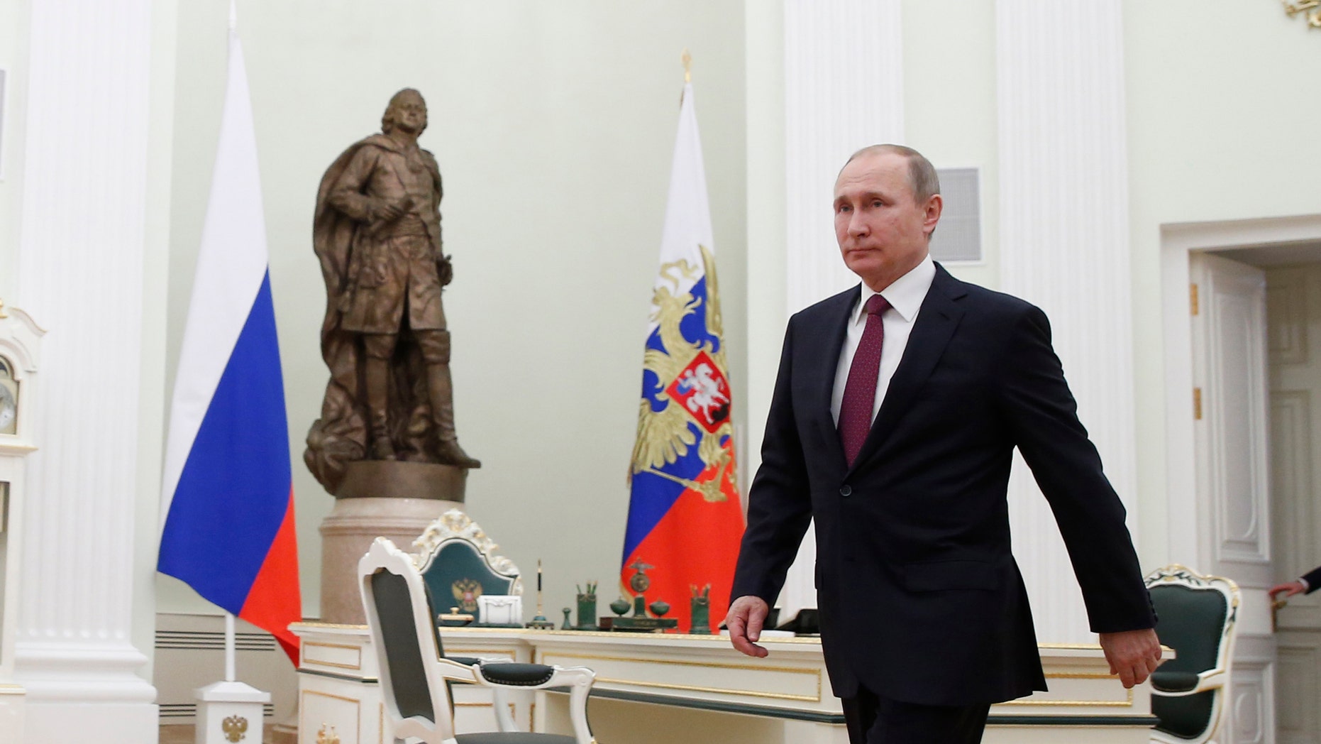 Russian President Vladimir Putin walks to meet with Moldovan President Igor Dodon in Moscow's, Kremlin, Russia, Tuesday, Jan. 17, 2017. Dodson is in Russia on an official visit. (Sergei Ilnitsky/Pool photo via AP)
