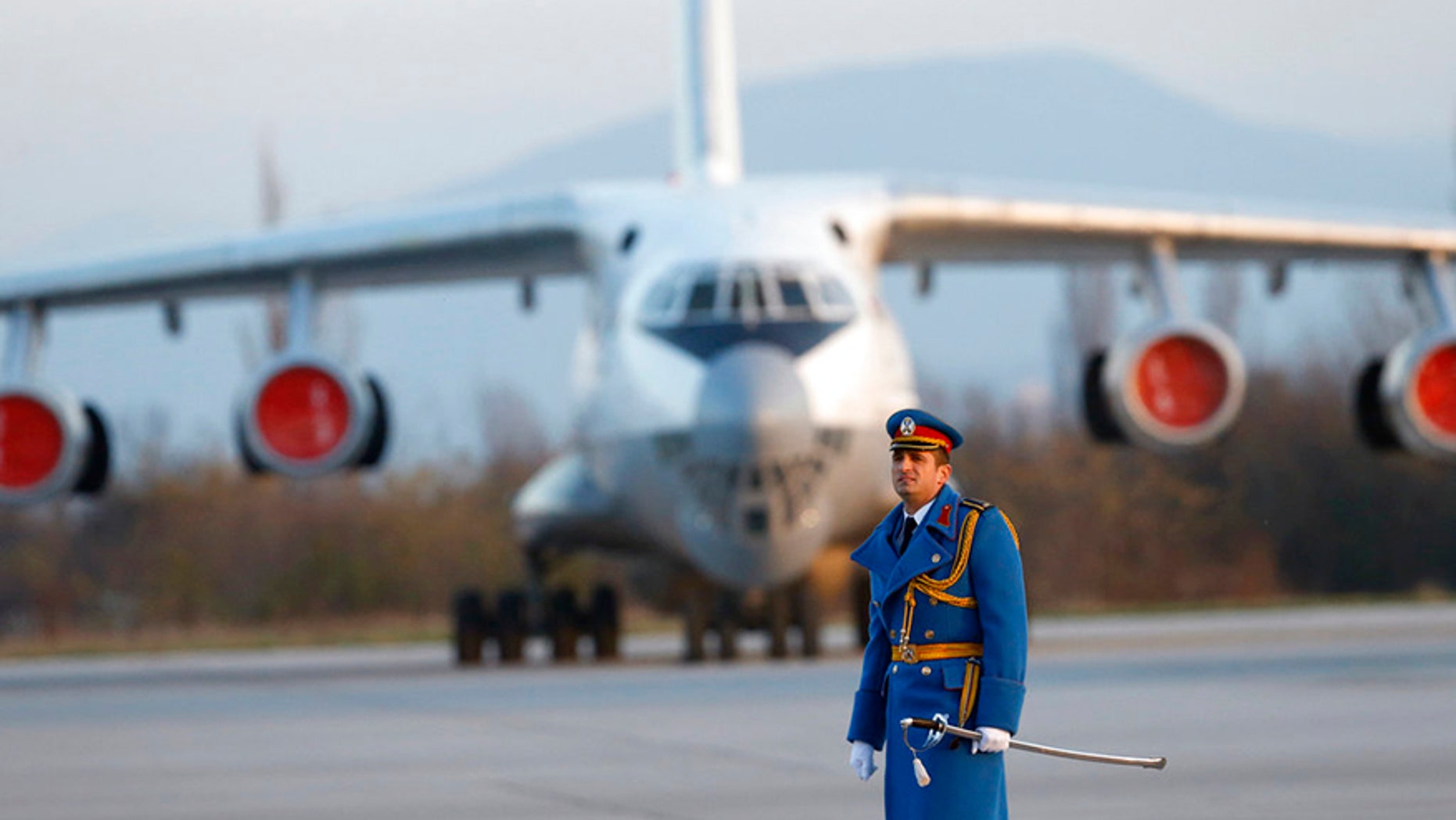 Serbian army officer walks in front of Soviet made heavy cargo plane Ilyushin Il-76 on the tarmac at the Constantine the Great Airport, near a "Russian-Serbian Humanitarian Center" in Serbia.