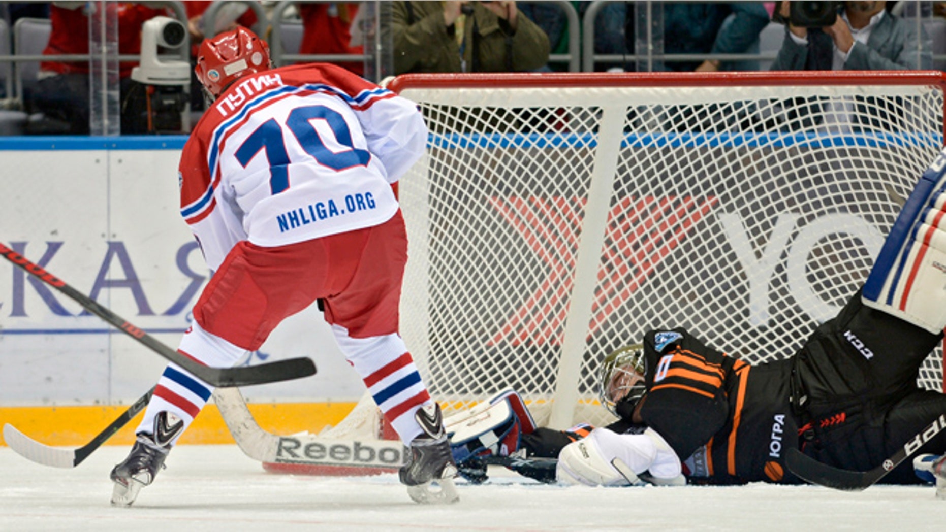 May 16, 2015: Russian President Vladimir Putin, back to a camera, scores during an exhibition hockey game at the Night Hockey League tournament in the Black Sea resort of Sochi, Russia. President Vladimir Putin has played in an exhibition hockey game and scored one goal after another on assists from retired NHL players.