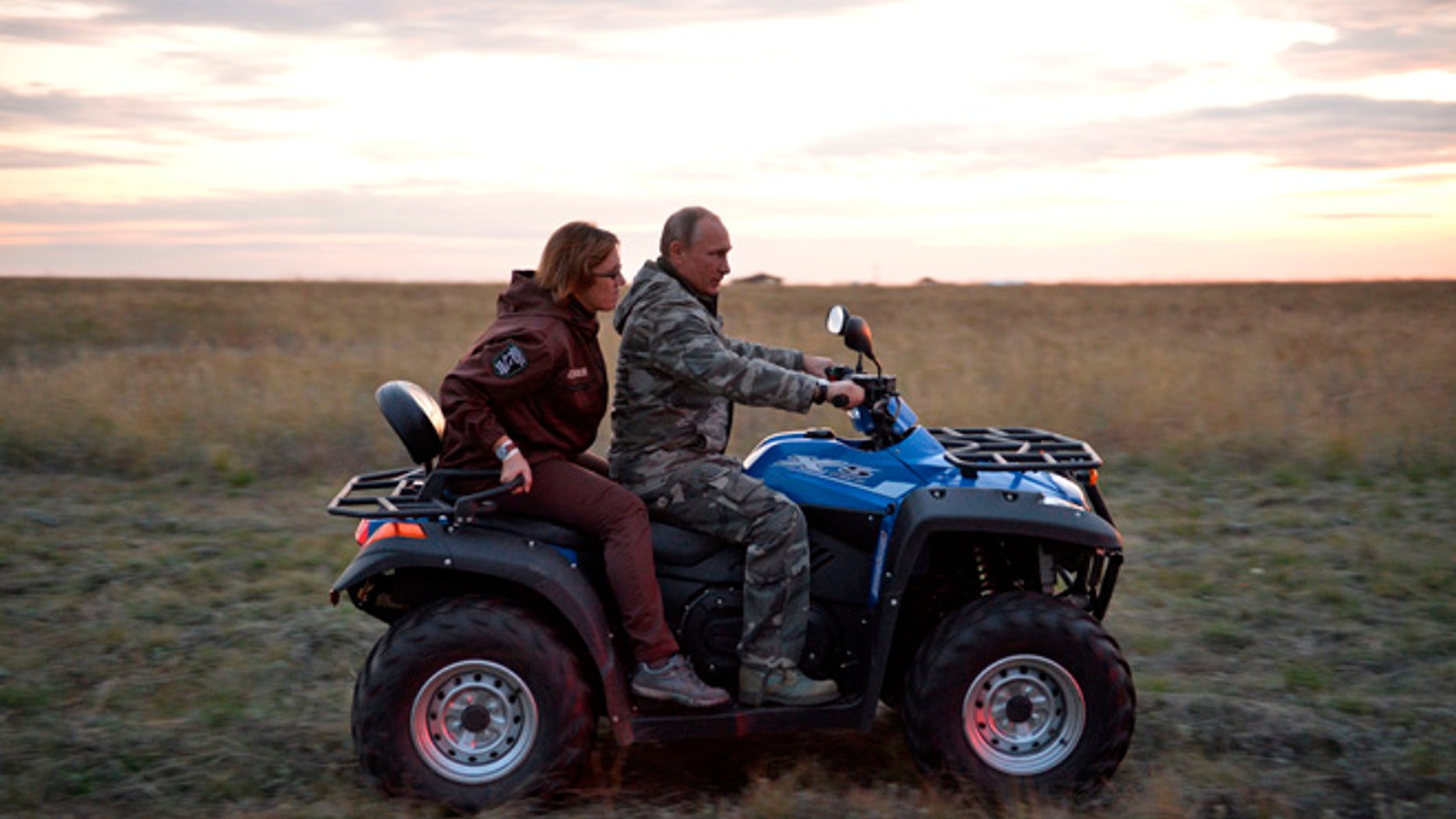 Russian President Vladimir Putin rides a quad bike as he visits a reserve for wild horses near the Urals city of Orenburg, about 800 miles southeast of Moscow, Russia, Monday, Oct. 3, 2016.