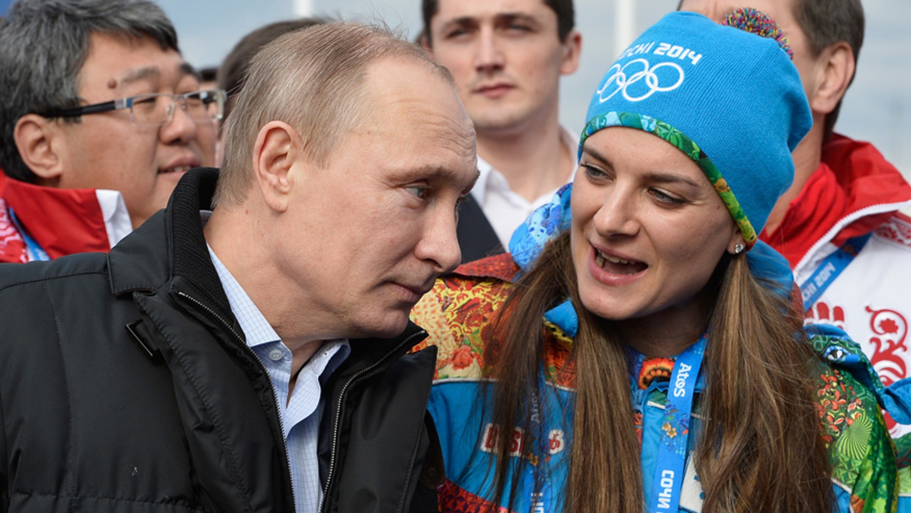 In this Feb. 5, 2014 file photo Russian President Vladimir Putin speaks with Olympic Village Mayor Elena Isinbaeva while visiting the Coastal Cluster Olympic Village ahead of the Sochi 2014 Winter Olympics in Sochi, Russia.