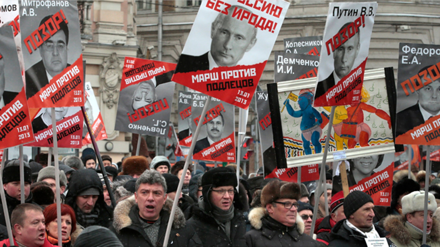 Some thousands of people are gathering in central Moscow for a protest against Russia's new law banning Americans from adopting Russian children, carrying posters of President Vladimir Putin and members of Russia's parliament who overwhelmingly voted for the law last month, with the word "Shame" written in red over the faces.