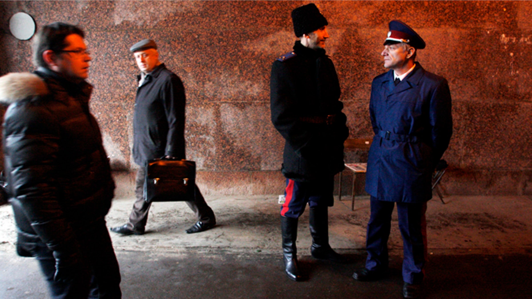 Nov. 27, 2012: Two Russian Cossacks, right, watch pedestrians passing by as they patrol Belorussky railway station in downtown Moscow, Russia.