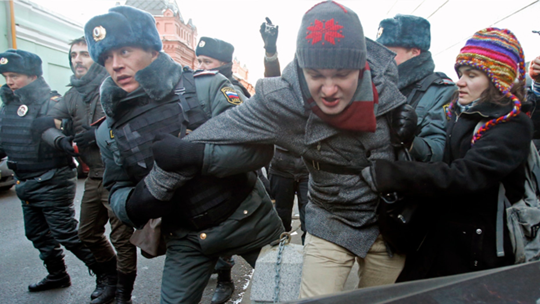 Dec. 19, 2012: In this Wednesday file photo police officers detain gay right activists during a protest near the State Duma, Russia's lower house of parliament, in Moscow, Russia.