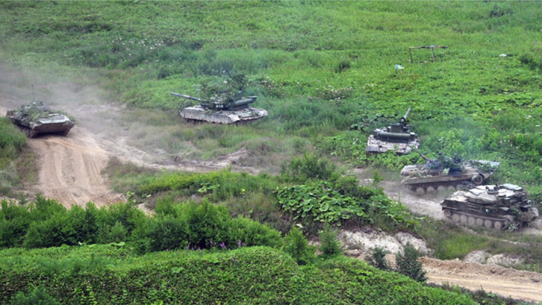 July 16, 2013: Russian Army tanks move at the Sakhalin Island during military exercises. The maneuvers in Siberia and the far eastern region involved 160,000 troops and about 5,000 tanks -- a massive show of force unprecedented since the Soviet times.