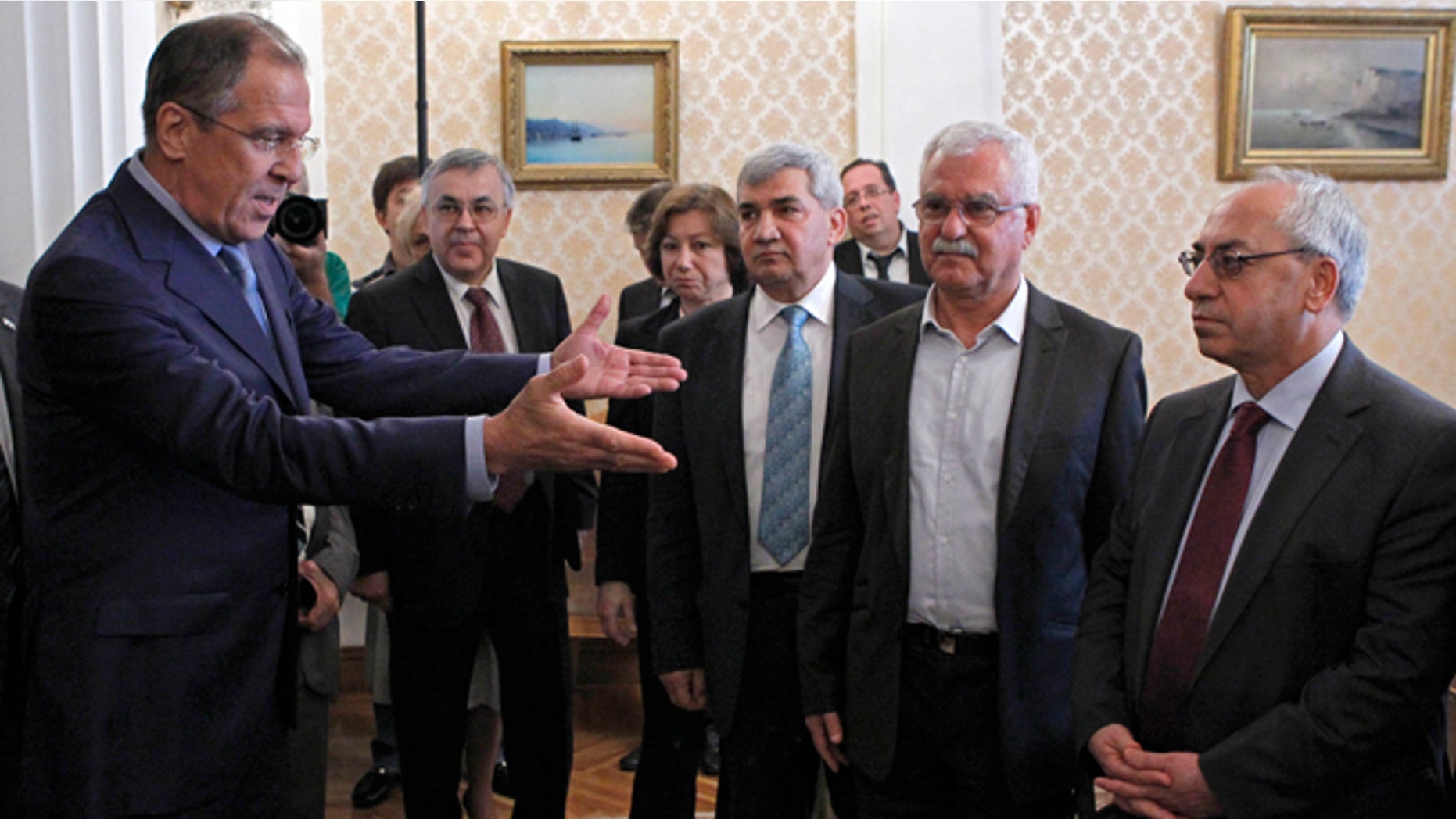 July 11, 2012: Russian Foreign Minister Sergey Lavrov, left, welcomes a delegation headed by a leader of the Syrian National Council (SNC), Abdulbaset Sieda, right, in Moscow, Russia.