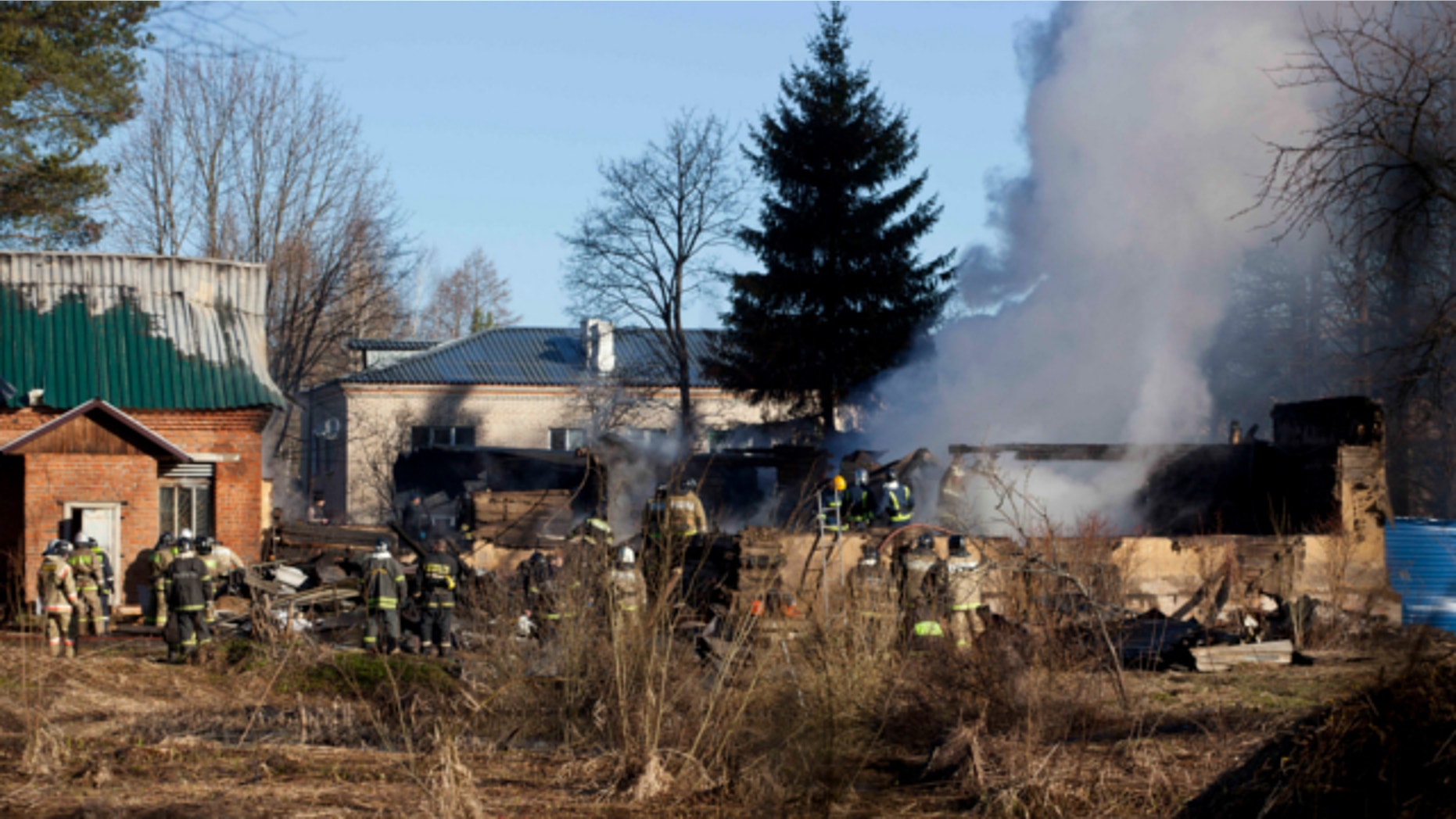 April 26, 2013: Ministry for Emergency Situations workers and fire fighters work at a site of a fire of a psychiatric hospital.
