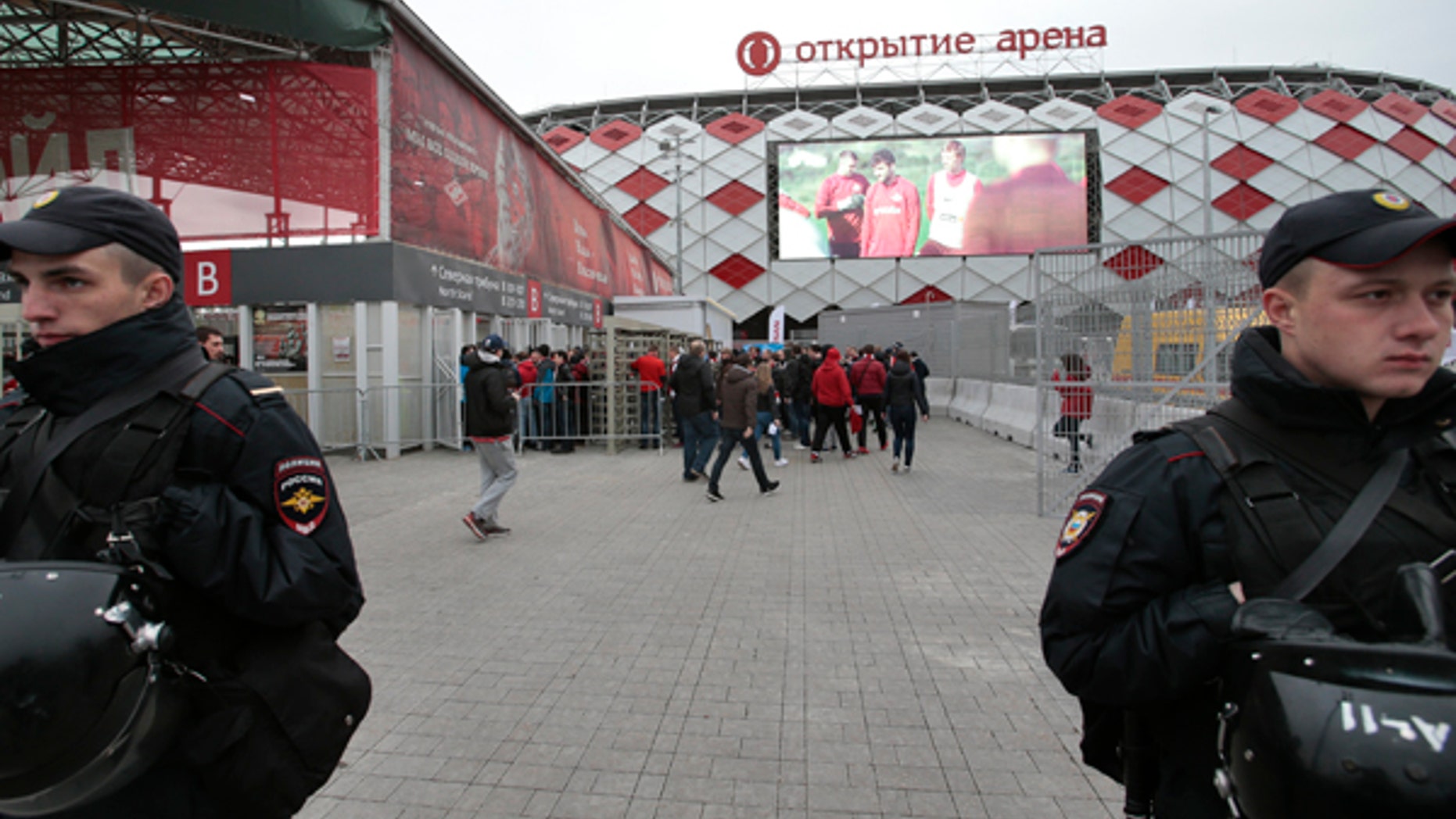 In this Wednesday, May 17, 2017 photo Russian police officers guard as fans arrive for a soccer match at Otkrytie Arena, stadium of Spartak Moscow soccer club, where Confederations Cup matches will be played, in Moscow, Russia. Terrorists, hooligans and anti-corruption protesters are among the main concerns for the Russian security forces during the Confederations Cup soccer tournament running from Saturday June 17 until Sunday July 2. (AP Photo/Ivan Sekretarev)