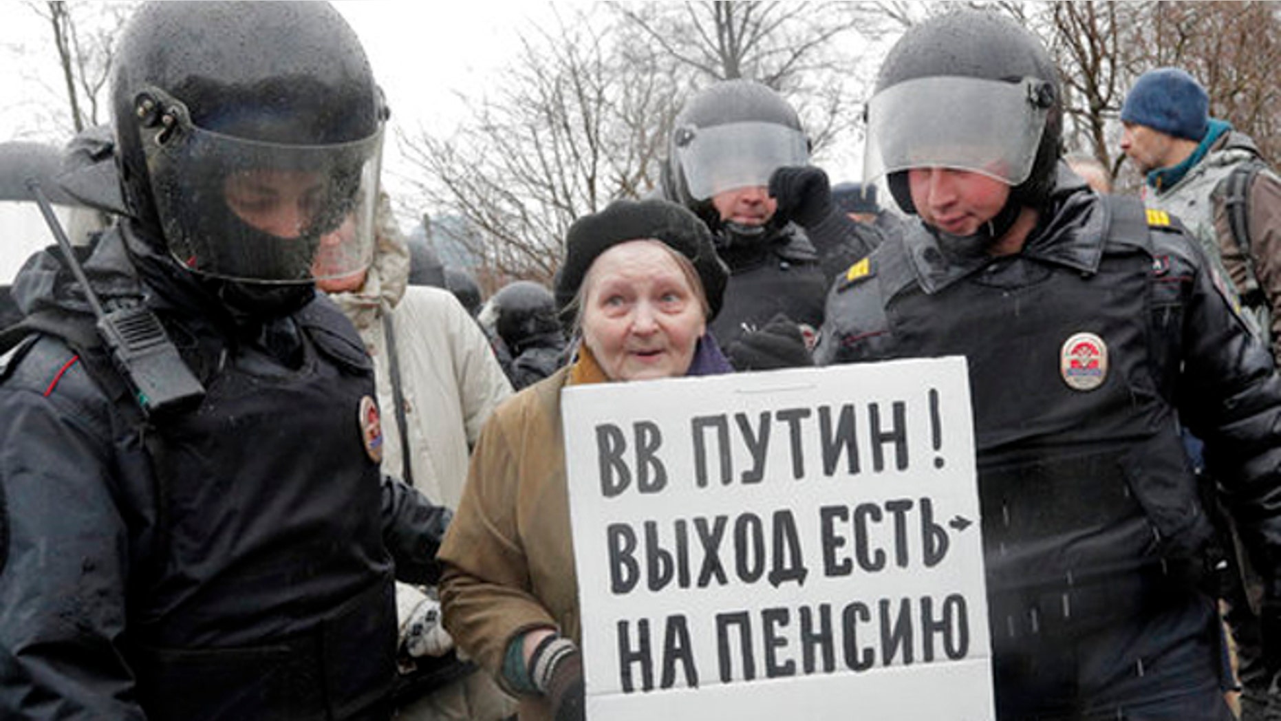 Policemen detain a participant in an unauthorized rally in St. Petersburg, Russia, Saturday.