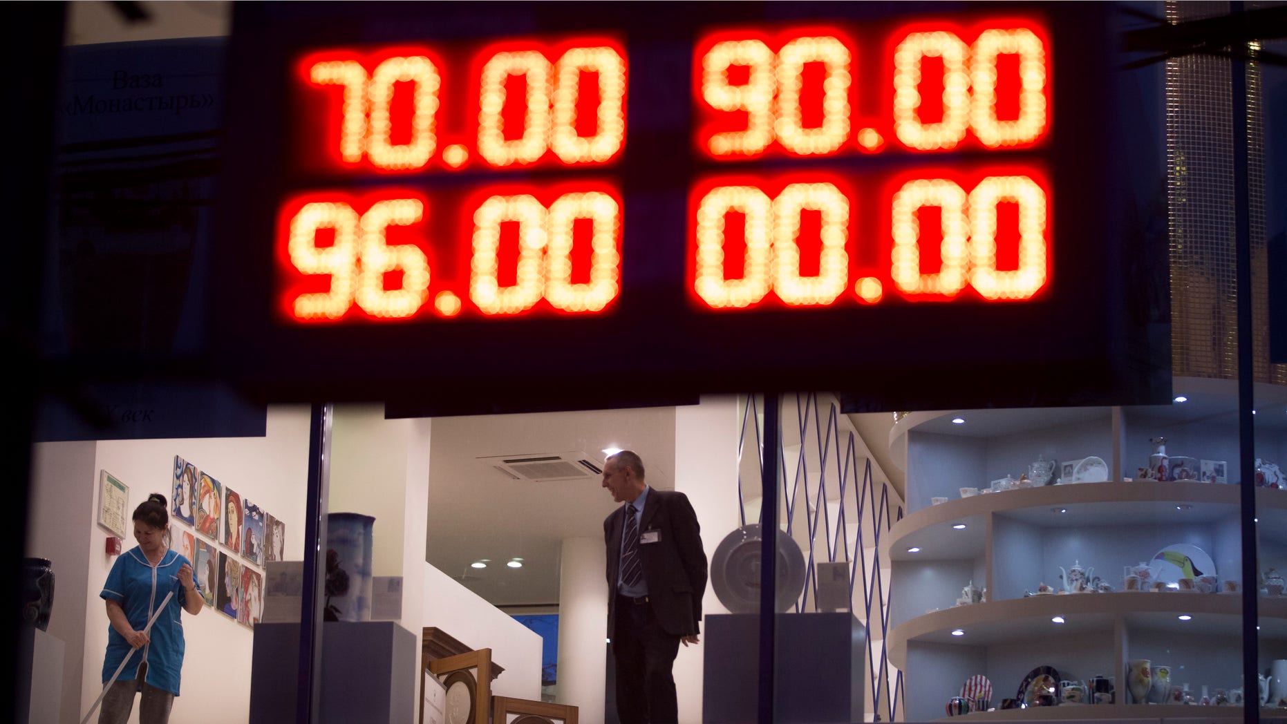 Dec. 16, 2014: An electronic board shows exchange rates for the Dollar, top, and the Euro, bottom, next to a luxury St. Petersburg china's shop in Moscow, Russia.
