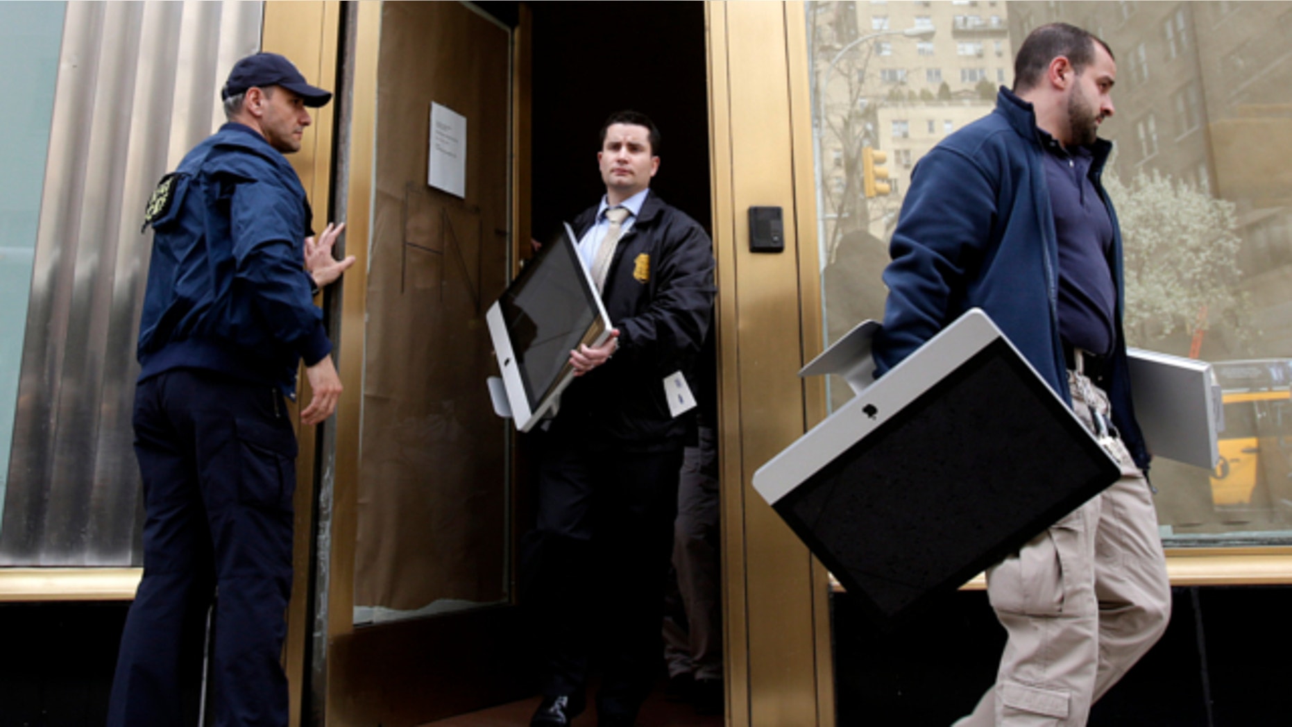 April 16, 2013: Federal agents remove items, including computers, from an art gallery in New York.
