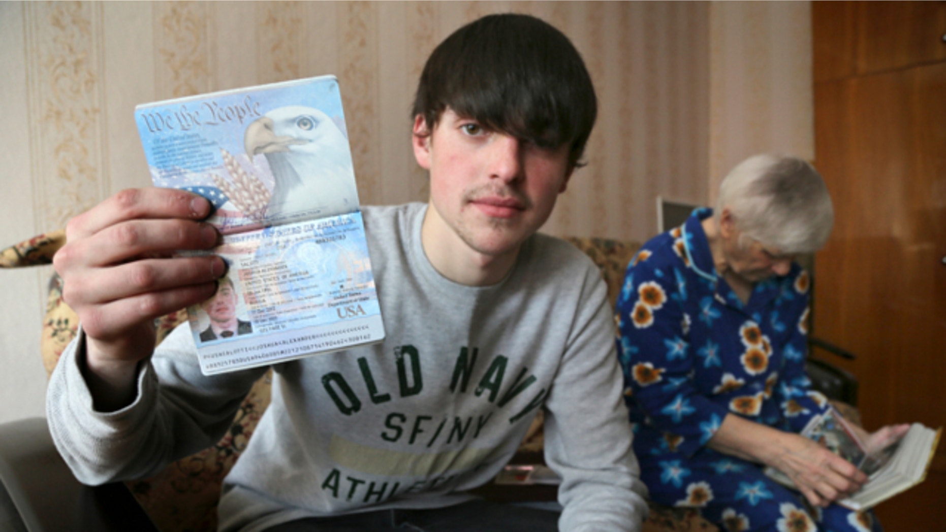 March 20, 2013: Alexander Abnosov shows his American passport to journalists in the Volga river city of Cheboksary, Russia.