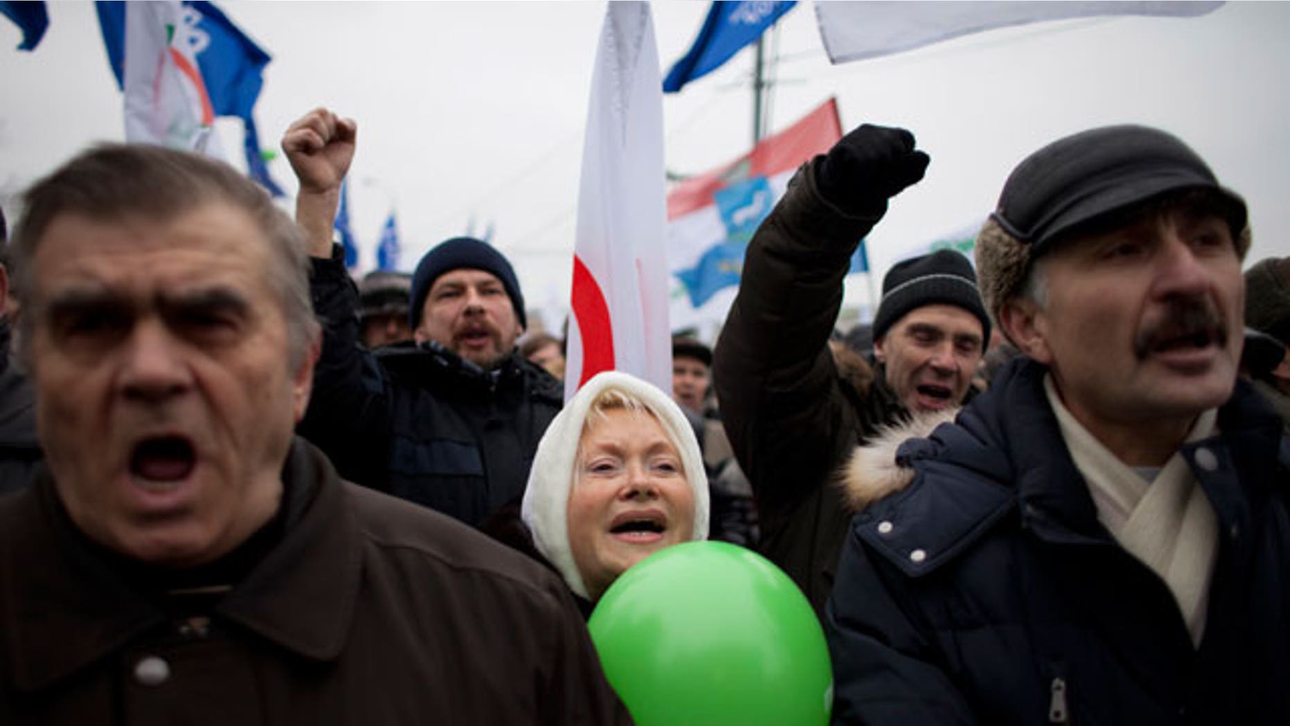 Dec. 17, 2011: With Yabloko party flags in the background, Russian protesters shout slogans during a rally to protest against alleged vote rigging at Bolotnaya Square, on an island in the Moscow River adjacent to the Kremlin in Moscow, Russia.