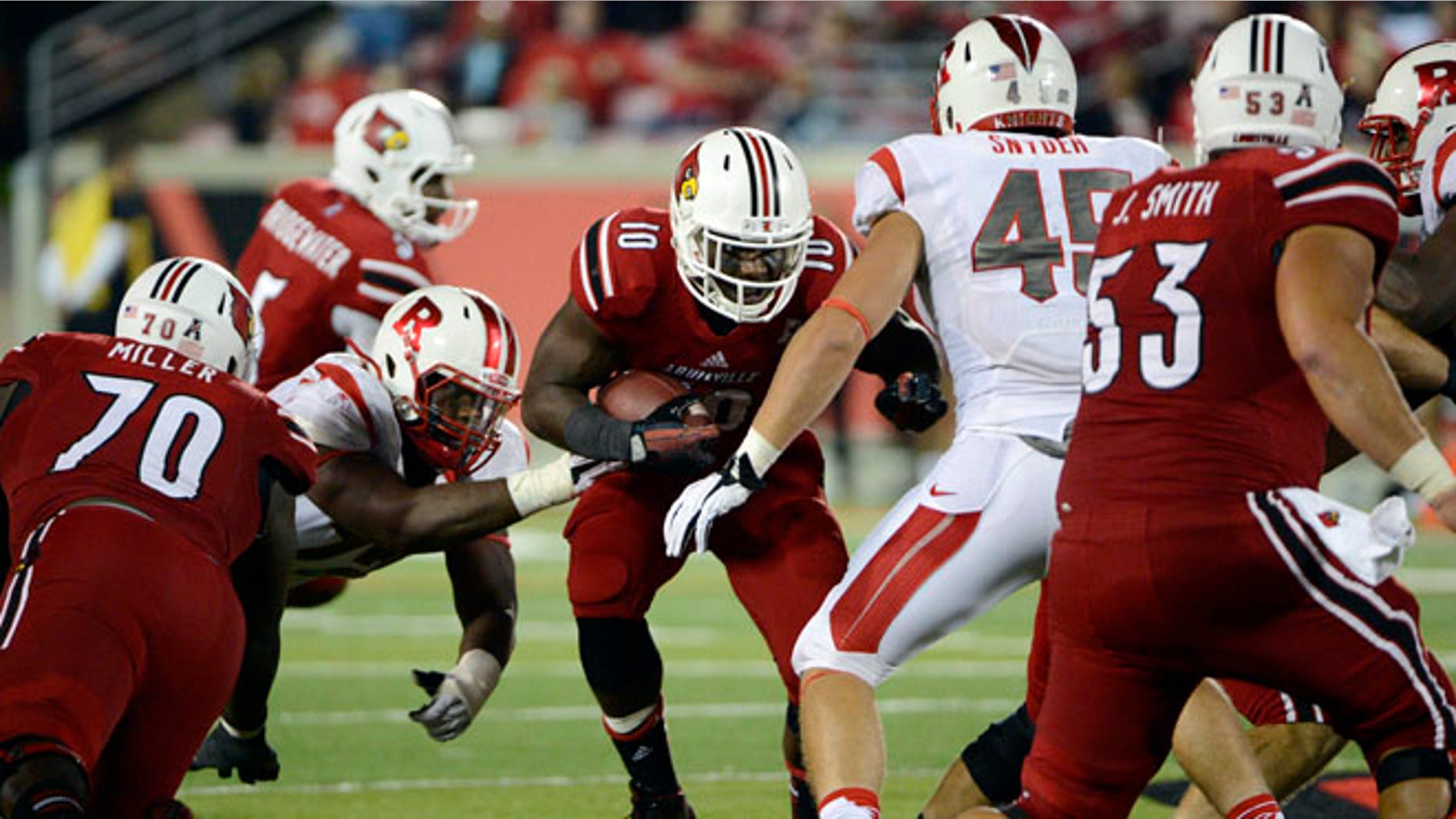 Oct 10, 2013;Louisville Cardinals running back Dominique Brown (10) runs the ball against Rutgers Scarlet Knights linebacker Kevin Snyder (45) during the second half at Papa John's Cardinal Stadium.