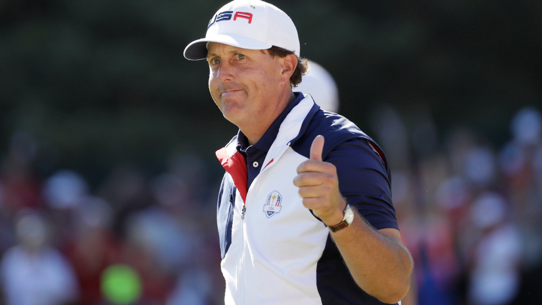 Phil Mickelson gives a thumbs up after playing the 15th hole during a singles match at the Ryder Cup tournament.