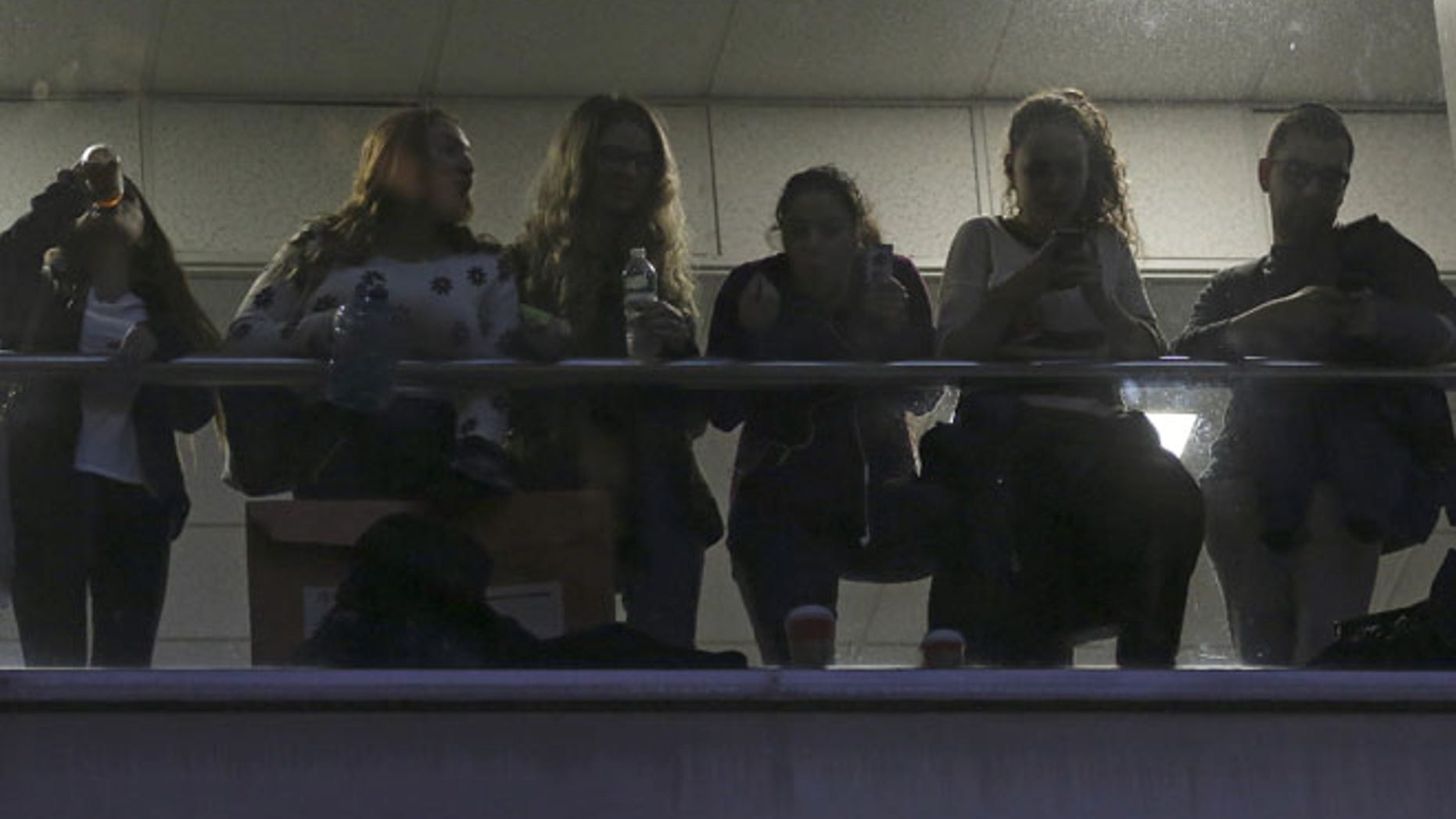 Students watch from a balcony during a demonstration calling for lower tuition at Hunter College in New York