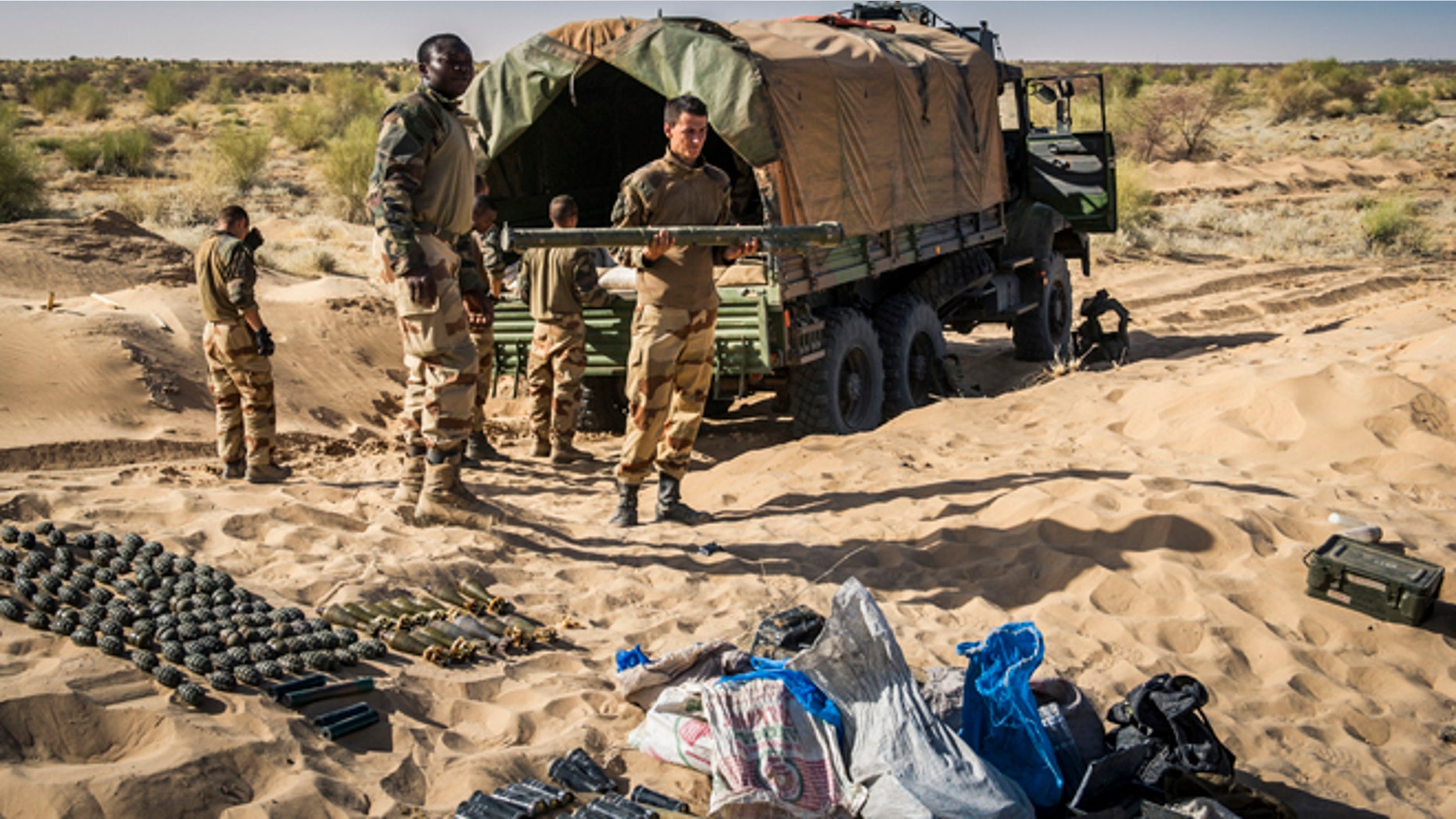 In this March 29, 2013 photo provided by the French Army's images division, ECPAD, a French soldier holds the launch tube of an SA-7 surface-to-air missile before its destruction in Timbuktu, northern Mali. The knowledge that the terrorists have the weapon has already changed the way the French are carrying out their five-month-old offensive in Mali. They are using more fighter jets rather than helicopters to fly above its range of 1.4 miles from the ground, even though that makes it harder to attack the jihadists. They are also making cargo planes land and take off more steeply to limit how long they are exposed, in line with similar practices in Iraq after an SA-14 hit the wing of a DHL cargo plane in 2003.