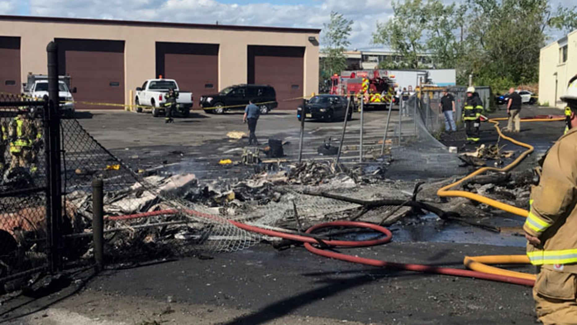 MAY 15: In this image provided by the Town of Carlstadt firefighters respond after a jet crashed into a building near Teterboro Airport in Carlstadt, N.J.