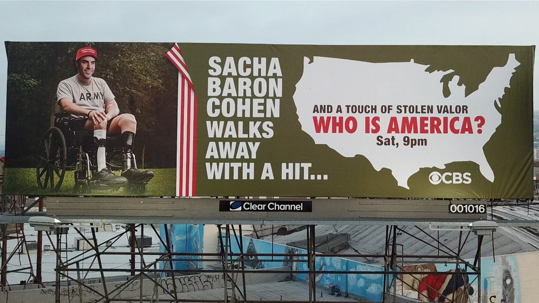 Street artist Sabo has posted a billboard that accuses Sacha Baron Cohen of stolen valor.