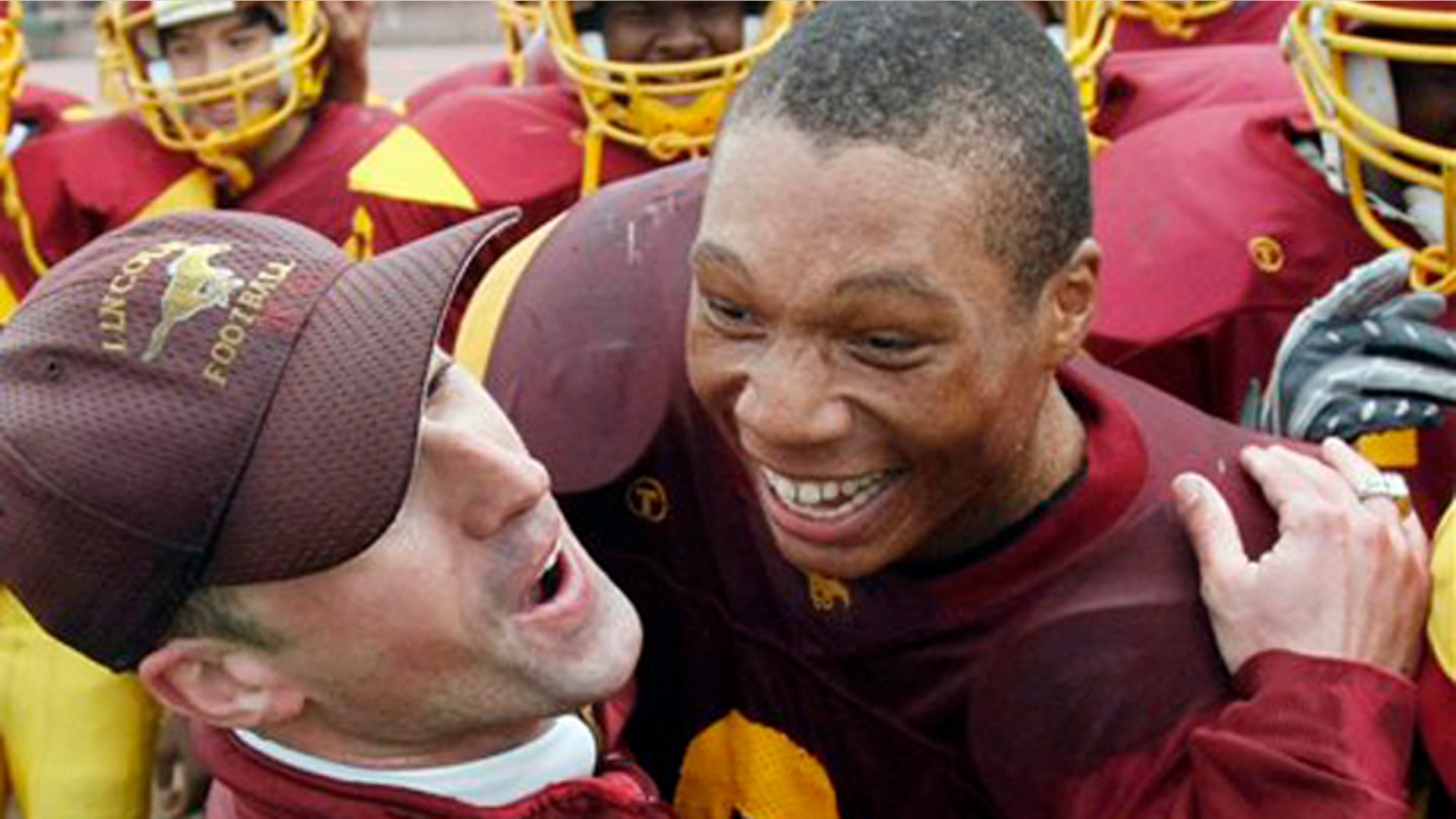 In this file photo taken Nov. 27, 2008, Lincoln Assistant Coach Kevin Doherty, left, hugs running back DeShon Marman as Lincoln defeated Washington in the annual Academic Athletic Association (AAA), San Francisco championship high school football game in San Francisco.