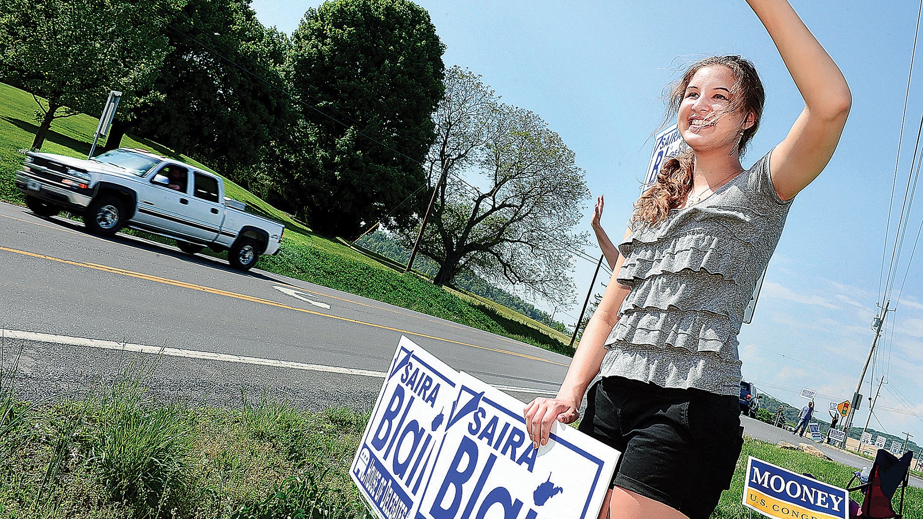 May 13, 2014: Saira Blair, a 17-year-old student at Hedgesville High School, waves to motorists along Route 9 in Hedgesville, W. Va.