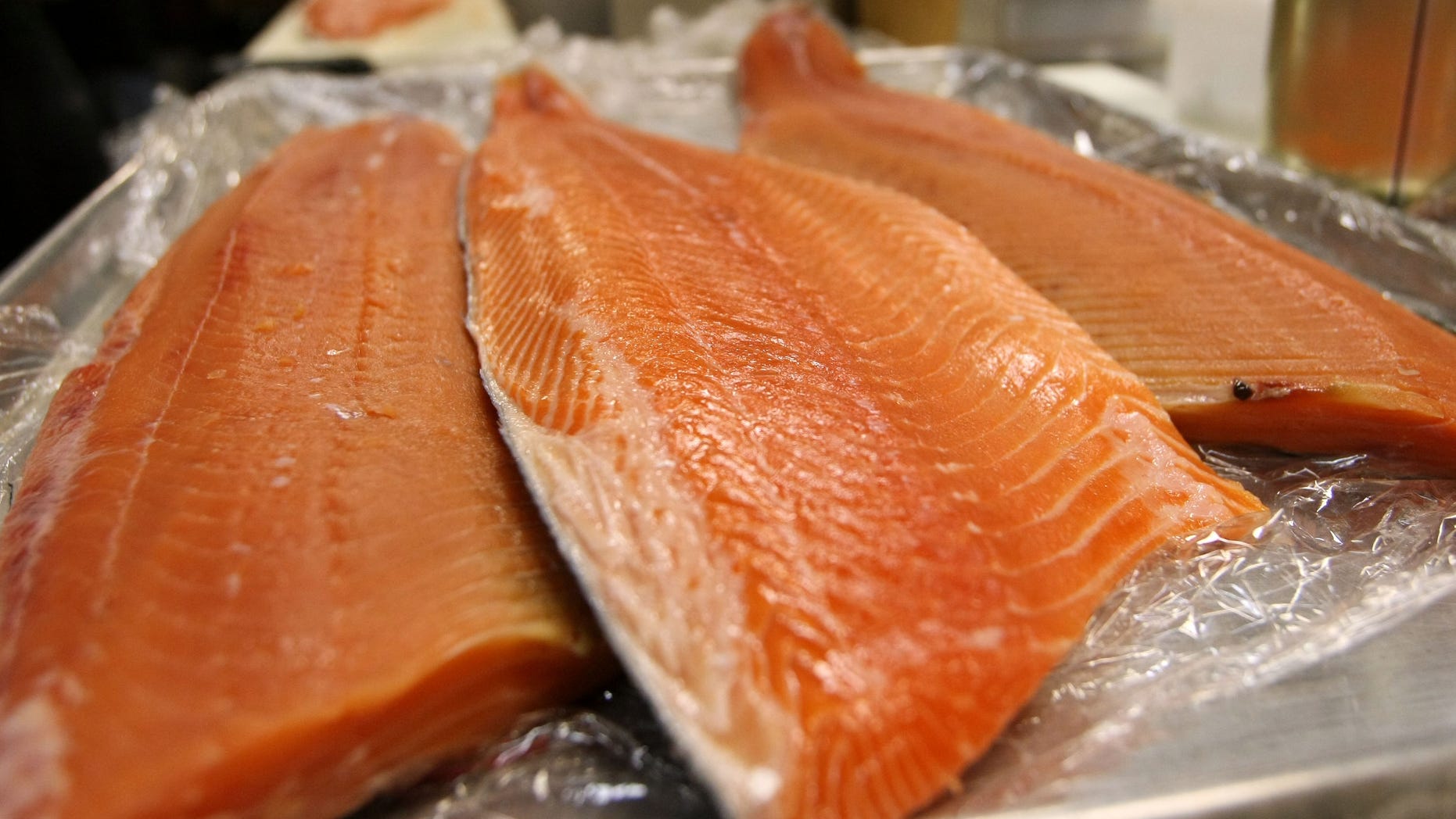 SAN FRANCISCO - APRIL 11: Fresh wild and farmed Loch Duart salmon filets are seen on a tray at the San Francisco Fish Company April 11, 2008 in San Francisco, California. The Pacific Fishery Management Council voted Thursday afternoon to cancel the chinook fishing season along the coast of California and Oregon in hopes of reversing the dwindling numbers of salmon. Farmed salmon will be a popular replacement for fresh wild salmon on seafood store shelves during the fishing ban. (Photo by Justin Sullivan/Getty Images)