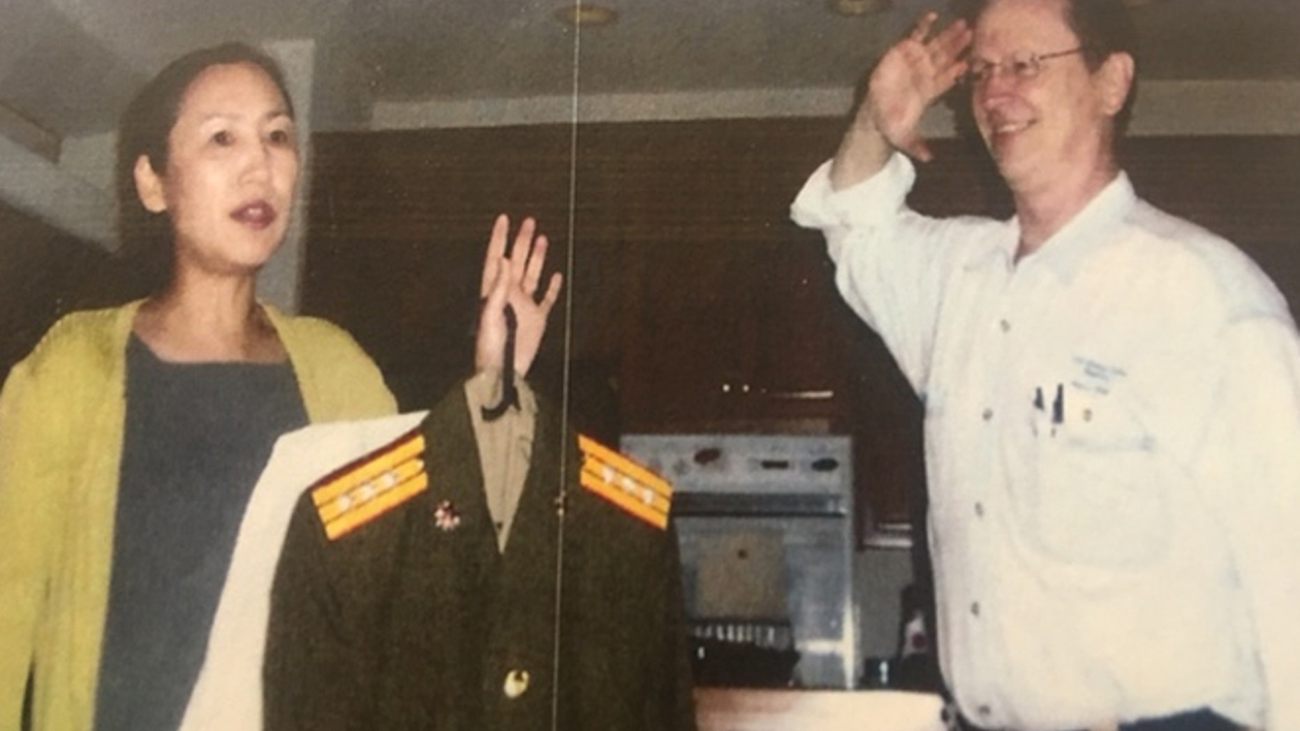 Undated photo: UMT academic dean J. Davidson Frame, right, salutes his wife, left, UMT president Yanping Chen Frame.
