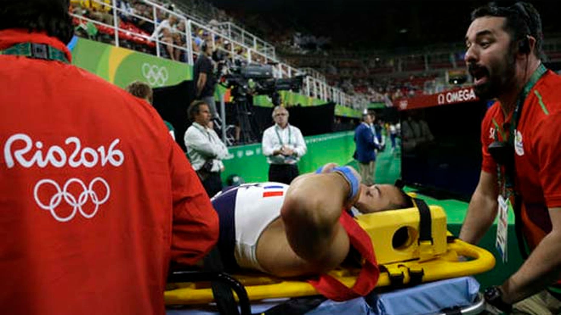 France's Samir Ait Said is carried away on a stretcher after he injured himself while performing on the vault during the artistic gymnastics men's qualification at the 2016 Summer Olympics Saturday.