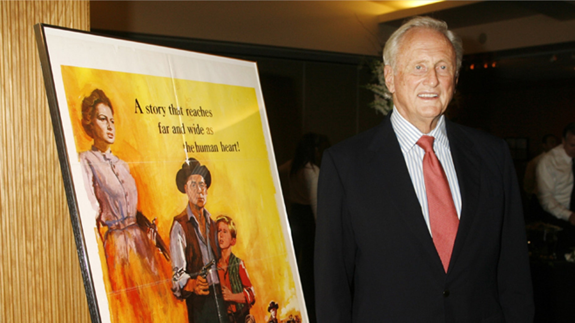 June 15, 2006. Producer Samuel Goldwyn Jr. stands next to a poster of his film "The Proud Rebel" as he arrives for "An Academy Tribute to Olivia de Havilland" at the Academy of Motion Picture Arts & Sciences in Beverly Hills.