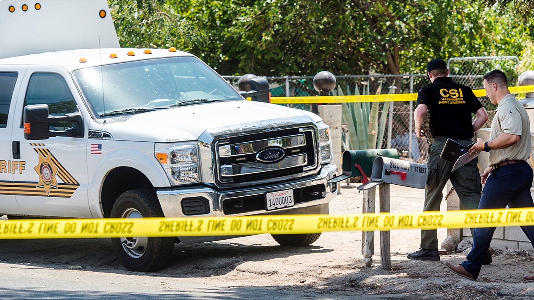 San Bernardino County Sheriff's personnel investigate the scene of a fatal shooting in Muscoy, Calif., on Friday.