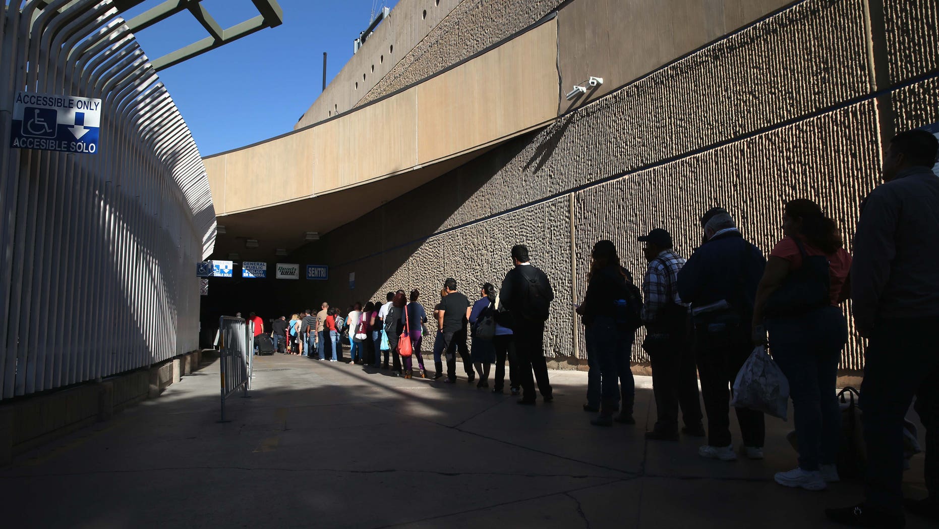 SAN DIEGO, CA - NOVEMBER 14: People wait in line to cross from Mexico into the United States at the San Ysidro port of entry on November 14, 2013 in San Diego, California. San Ysidro is the busiest port of entry into the United States. (Photo by John Moore/Getty Images)