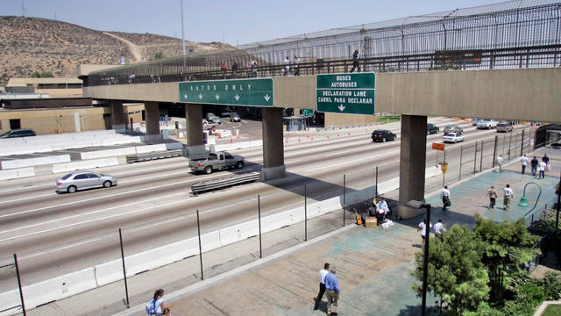 Pedestrians cross over Interstate 5 at the San Ysidro Border Crossing while others traveling into Mexico head under the bridge, July 23, 2007 in San Diego.