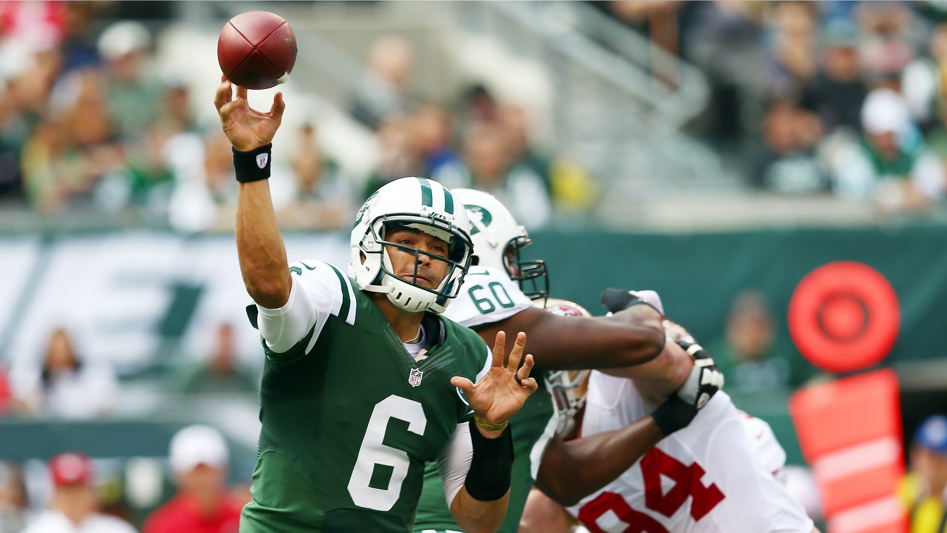 EAST RUTHERFORD, NJ - SEPTEMBER 30: Mark Sanchez #6 of the New York Jets passes the ball under pressure from Justin Smith #94 of the San Francisco 49ers on September 30, 2012 at MetLife Stadium in East Rutherford, New Jersey. (Photo by Elsa/Getty Images)