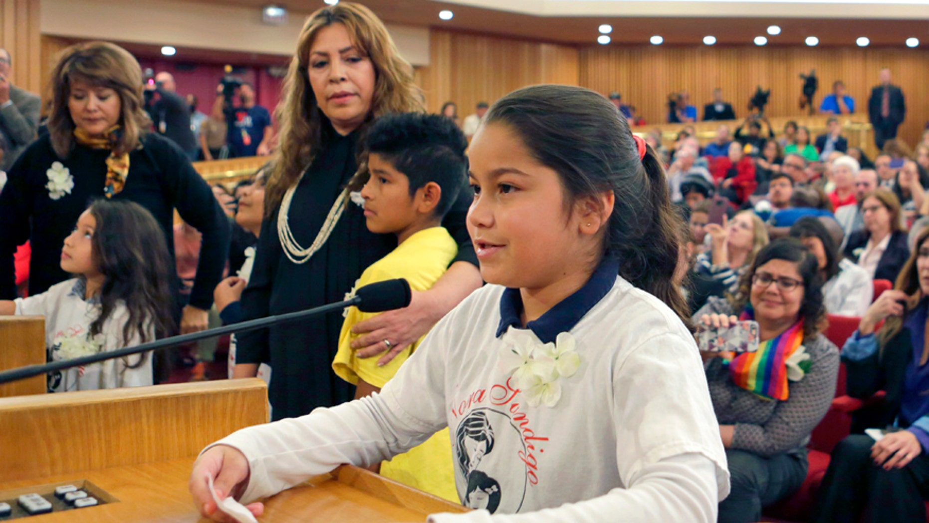 Shirley Vanegas, daughter of illegal immigrants, addresses Miami-Dade County commissioners in the county building, Friday, Feb. 17, 2017, in downtown Miami. Vanegas asked the commissioners to reverse Mayor Carlos Gimenez's position on immigration that requires local police to work with federal officers to enforce immigration law. (AP Photo/Alan Diaz)