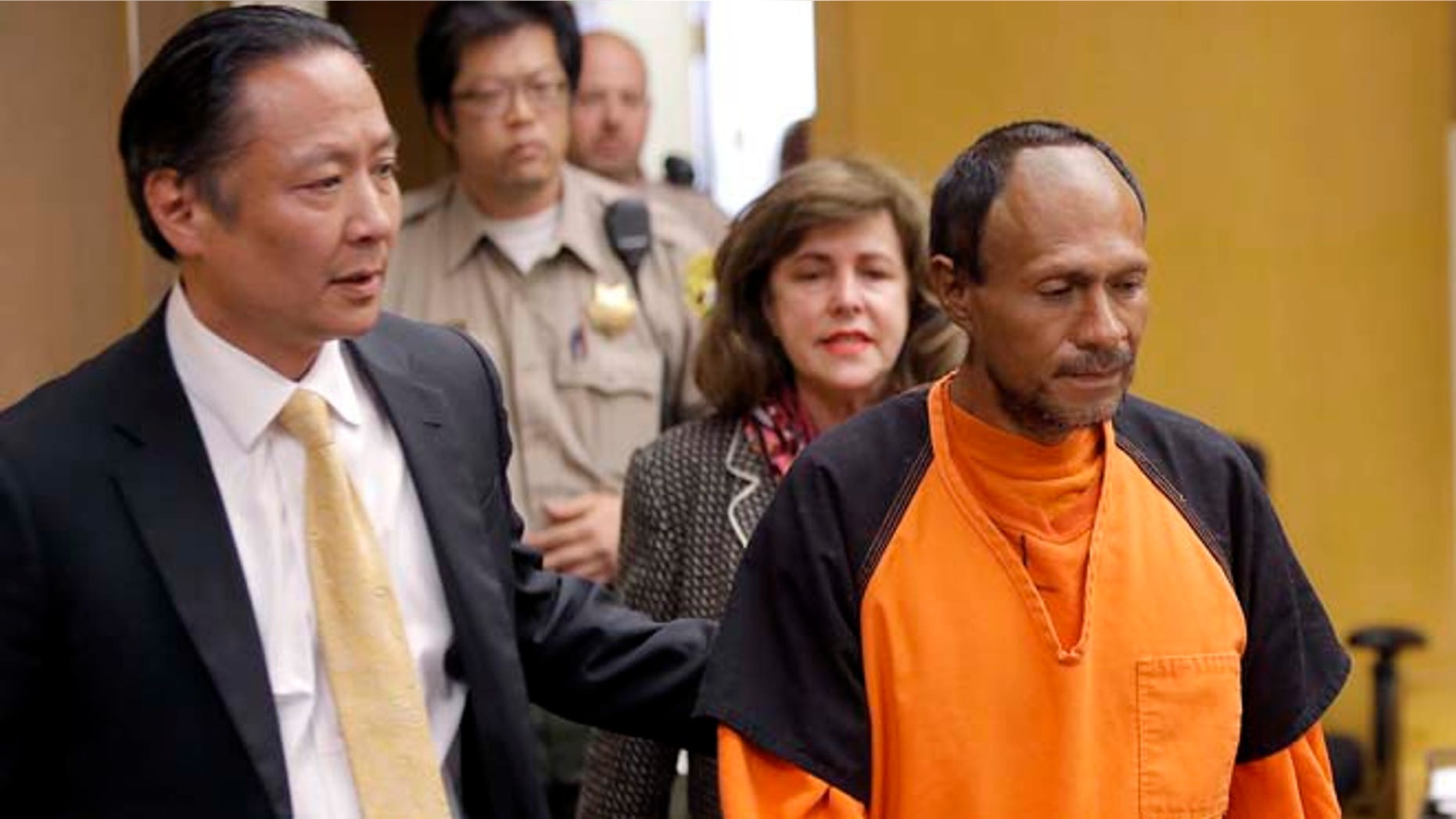 FILE - In this Tuesday, July 7, 2015 file photo, Juan Francisco Lopez-Sanchez, right, is lead into the courtroom by San Francisco Public Defender Jeff Adachi, left, and Assistant District Attorney Diana Garciaor, center, for his arraignment at the Hall of Justice in San Francisco. (Michael Macor/San Francisco Chronicle via AP, Pool, File)