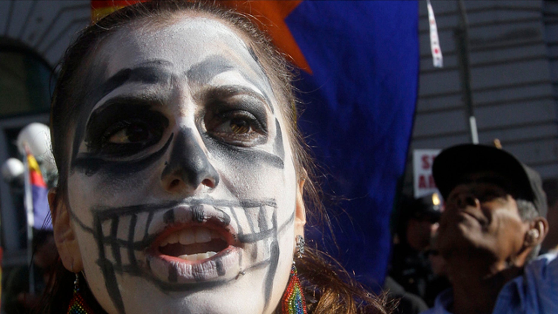 Nov. 1: Natalia Garcia Pasmanick yells at a protest of Arizona's new immigration law while Raymond Herrera, rear, holds up an Arizona flag in support of its immigration law outside of a U.S. Circuit Court of Appeals building in San Francisco, a sanctuary county and city that received $754,853 in SCAAP grant money in 2010. (AP Photo)