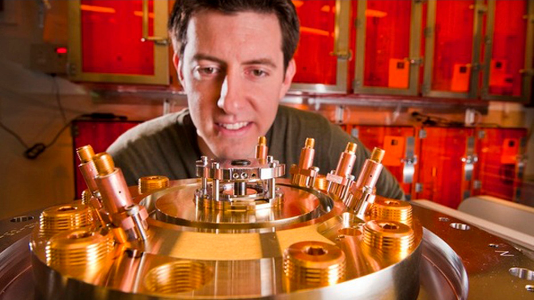Researcher Ryan McBride eyes the tiny beryllium liner to be imploded by the magnetic field that Sandia Labs Z machine generates.