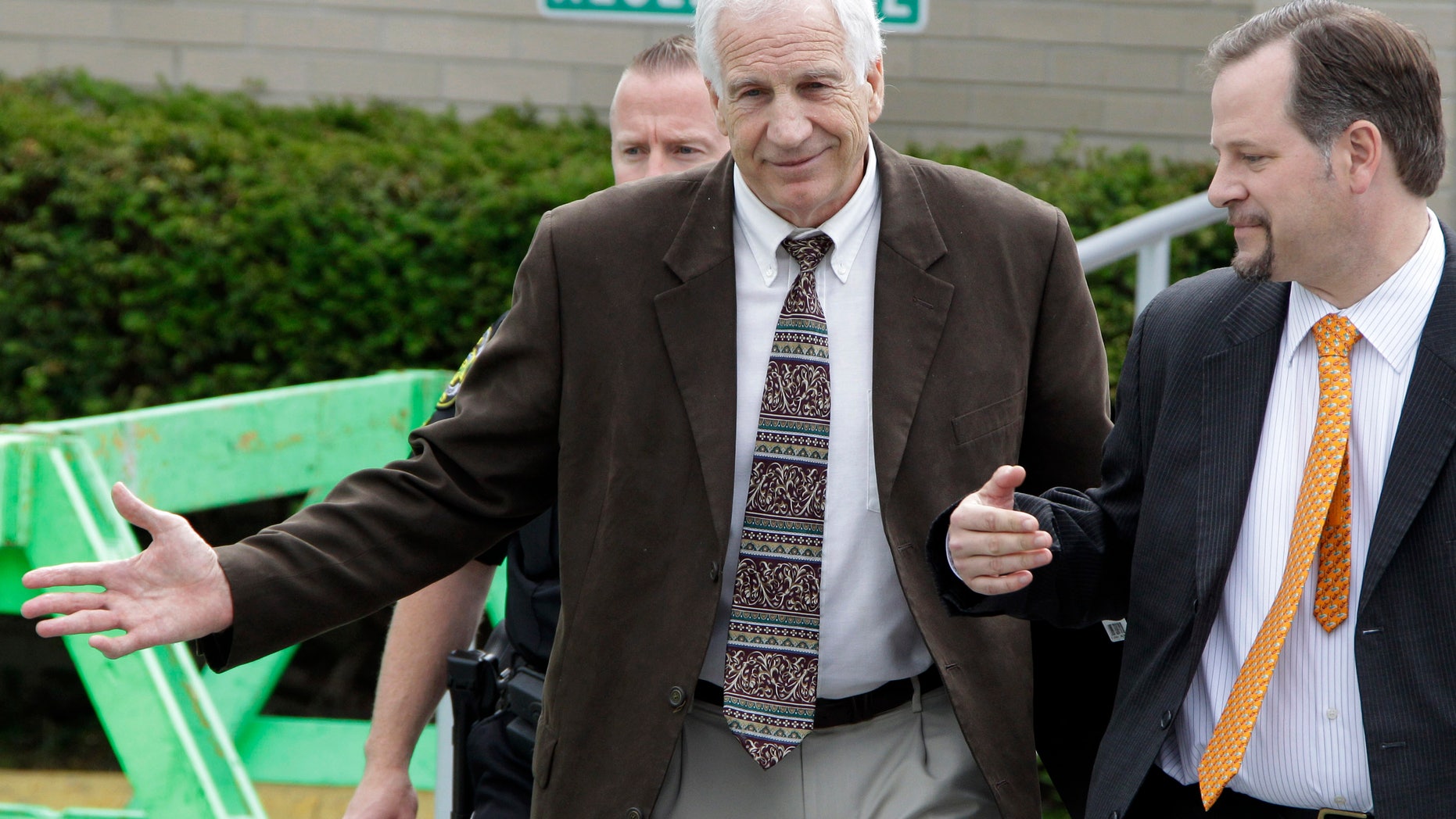June 6, 2012: Former Penn State assistant football coach Jerry Sandusky, center, leaves with attorney Karl Reminger, right, after jury selection was completed for Sandusky's trial on child sexual abuse charges, at the Centre County Courthouse in Bellefonte, Pa.