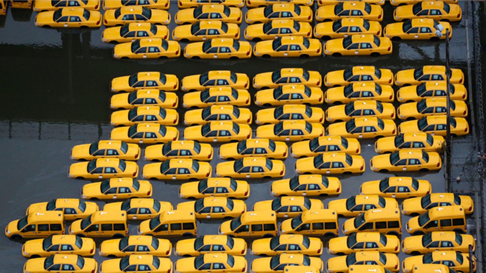 UNDATED: Flood damaged taxis in Weehawken, NJ, are among the thousands of cars that will need to be repaired or replaced in the coming weeks in the aftermath of superstorm Sandy.
