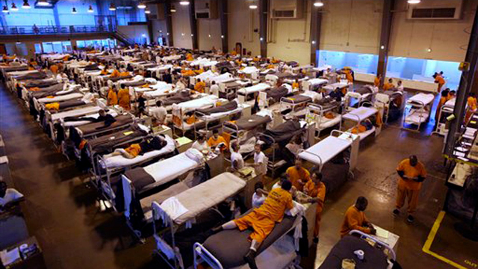 In this May 20, 2009 file photo, several hundred inmates crowd the gymnasium at San Quentin prison in San Quentin, Calif.