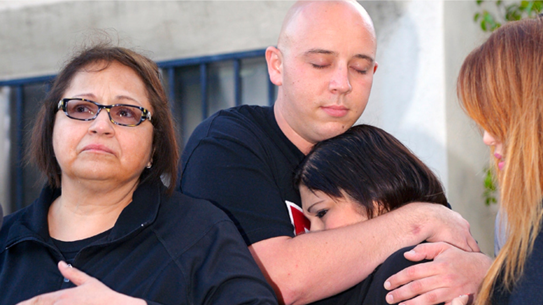 June 9, 2013: Margaret Quinonez-Perez, left, speaks to reporters during a news conference about victims Marcela Franco and father Carlos Navarro Franco who were both killed in Friday's deadly rampage shooting in Santa Monica, Calif. Letecia Franco, sister and daughter of the victims, second from right, cries with Ryan Payne, boyfriend of Marcela, as Sandra Franco, cousin to Marcela, watches.