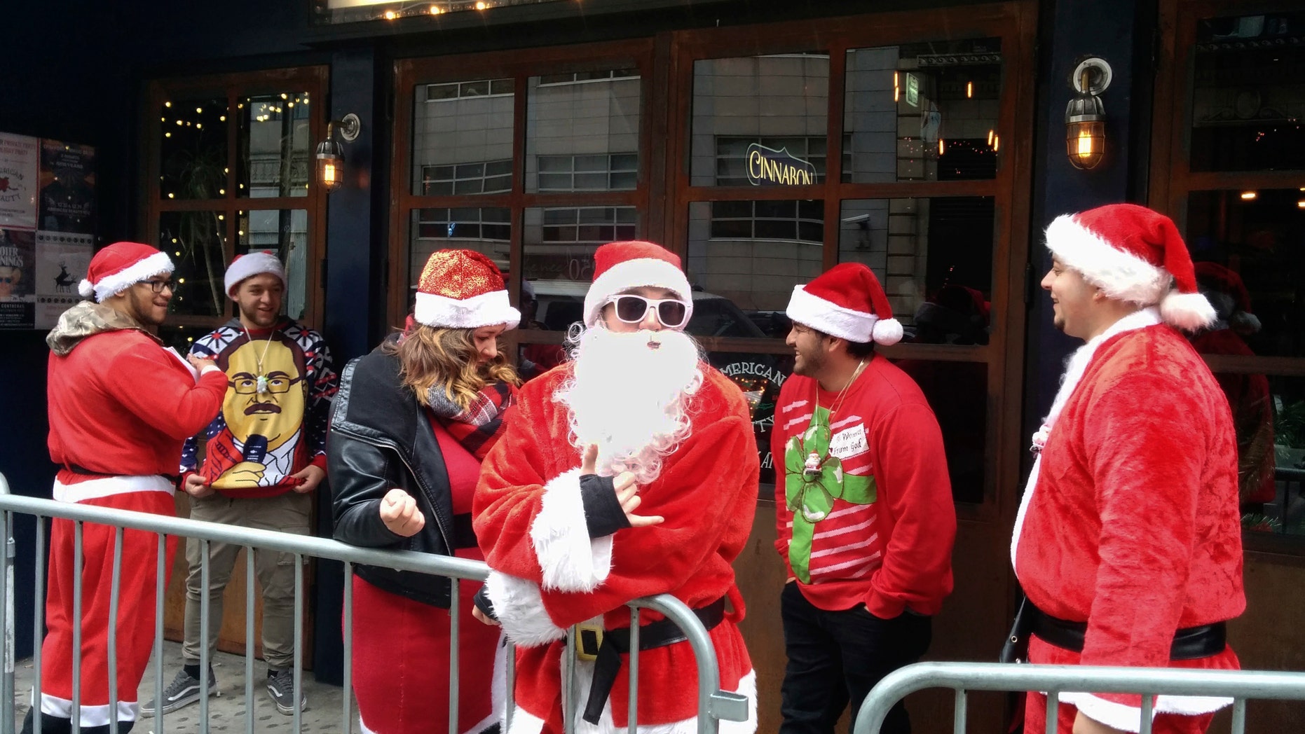 SantaCon revelers line up to enter a New York City tavern during last year's event, Dec. 10, 2016.