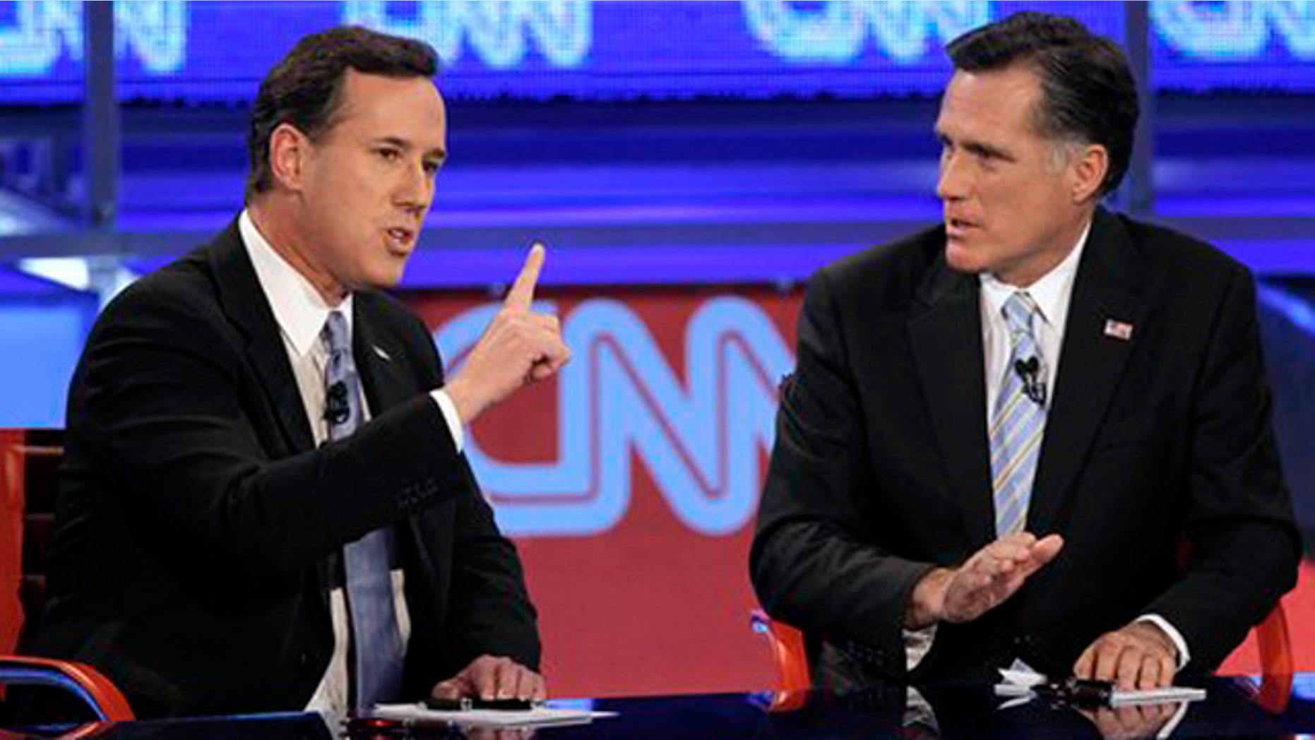 Feb. 22, 2012: Republican presidential candidate, former Pennsylvania Sen. Rick Santorum, left, makes a point as former Massachusetts Gov. Mitt Romney listens during a Republican presidential debate in Mesa, Ariz.