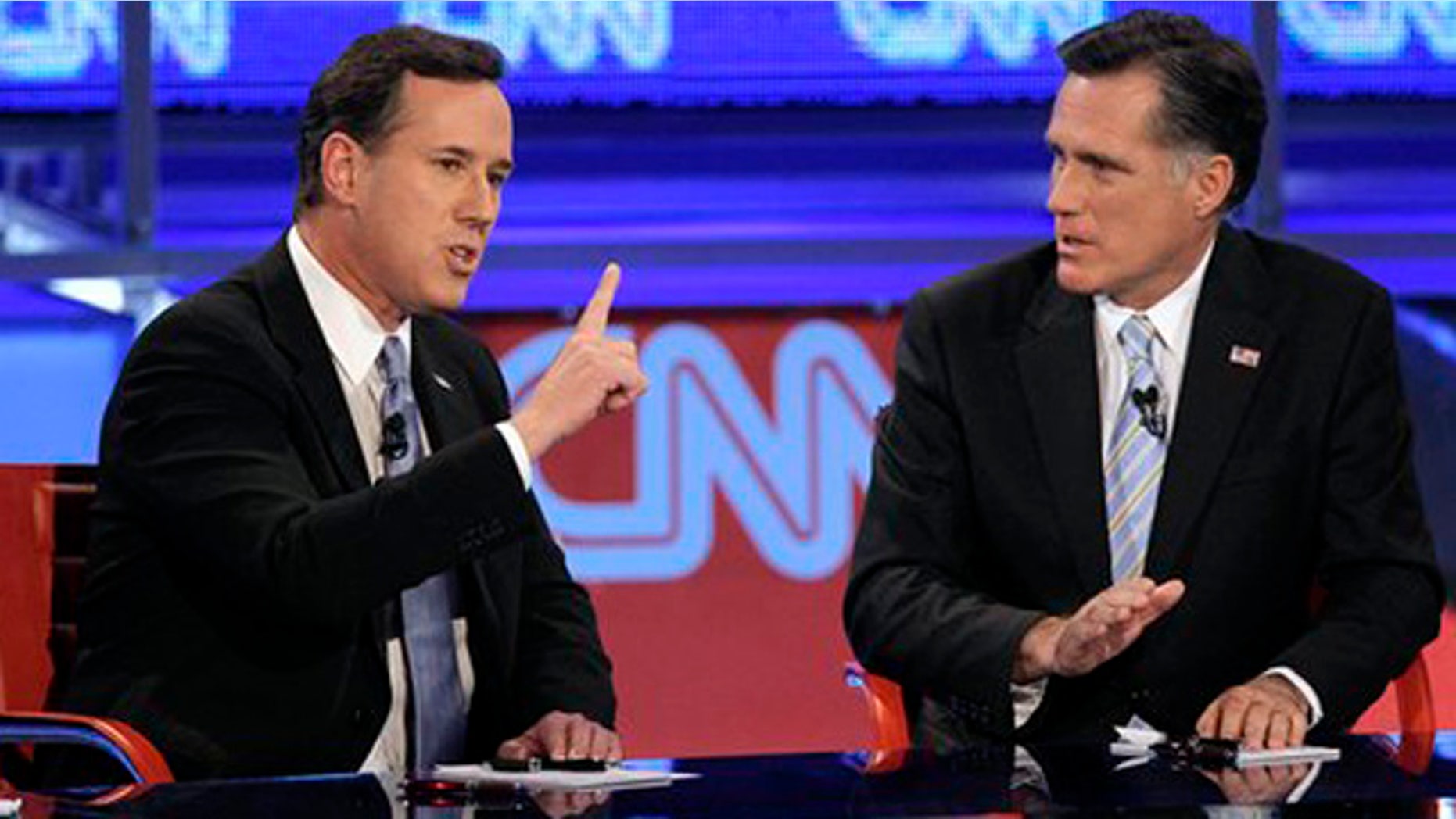 Feb. 22, 2012: Republican presidential candidate, former Pennsylvania Sen. Rick Santorum, left, makes a point as former Massachusetts Gov. Mitt Romney listens during a Republican presidential debate in Mesa, Ariz.