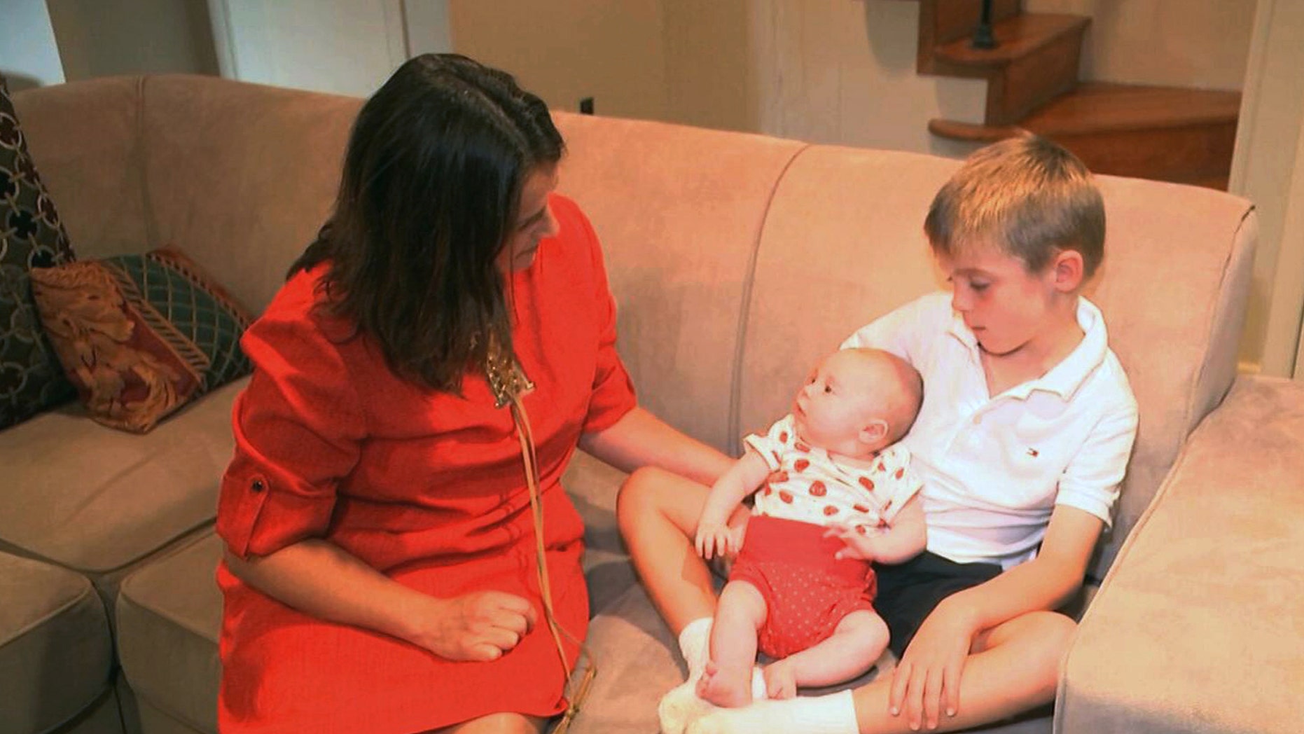 In this frame grab from video, taken Sept. 14, 2016, Sarah Gray with her son Callum, 6, and infant daughter Jocelyn in their Washington home. Callum's identical twin Thomas died of a birth defect when he was just 6 days old, and the family donated Thomas' eyes, liver and umbilical cord blood for medical research. Now Gray has written a book about her unusual journey to find out if that donation really made a difference, revealing a side of science laymen seldom glimpse.