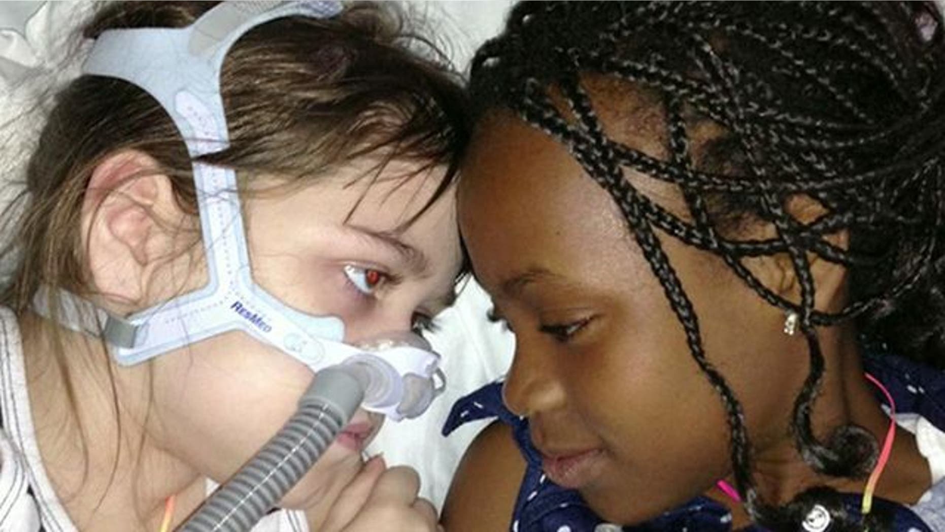 May 30, 2013: Sarah Murnaghan, left, lies in her hospital bed next to adopted sister Ella on the 100th day of her stay in Children's Hospital of Philadelphia.