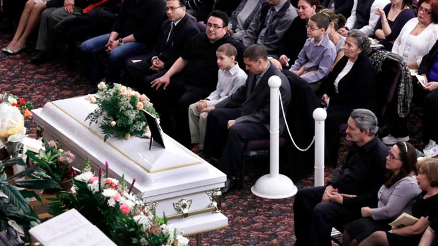 Feb. 15, 2013: Steven Sierra, husband of Sarai Sierra, upper center, with his son Silas Sierra, age 9, and Dennis Jimenez, second from right, father of Sarai Sierra, with his wife Betzaida Jimene, attend her funeral, at the Christian Pentecostal Church, in the Staten Island borough of New York. The 33-year-old mother of two was killed while vacationing alone in Turkey. Her body was found in Istanbul, 12 days after she disappeared.