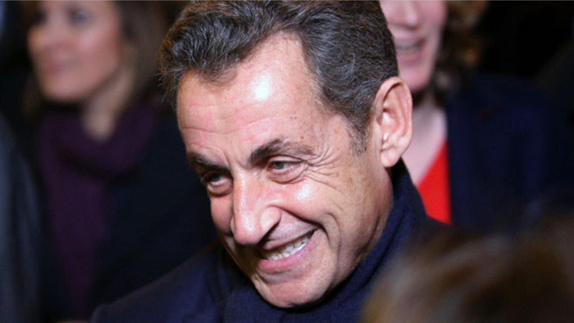 Nov. 29, 2014: Former French President Nicolas Sarkozy leaves his headquarters, in Paris. (AP)