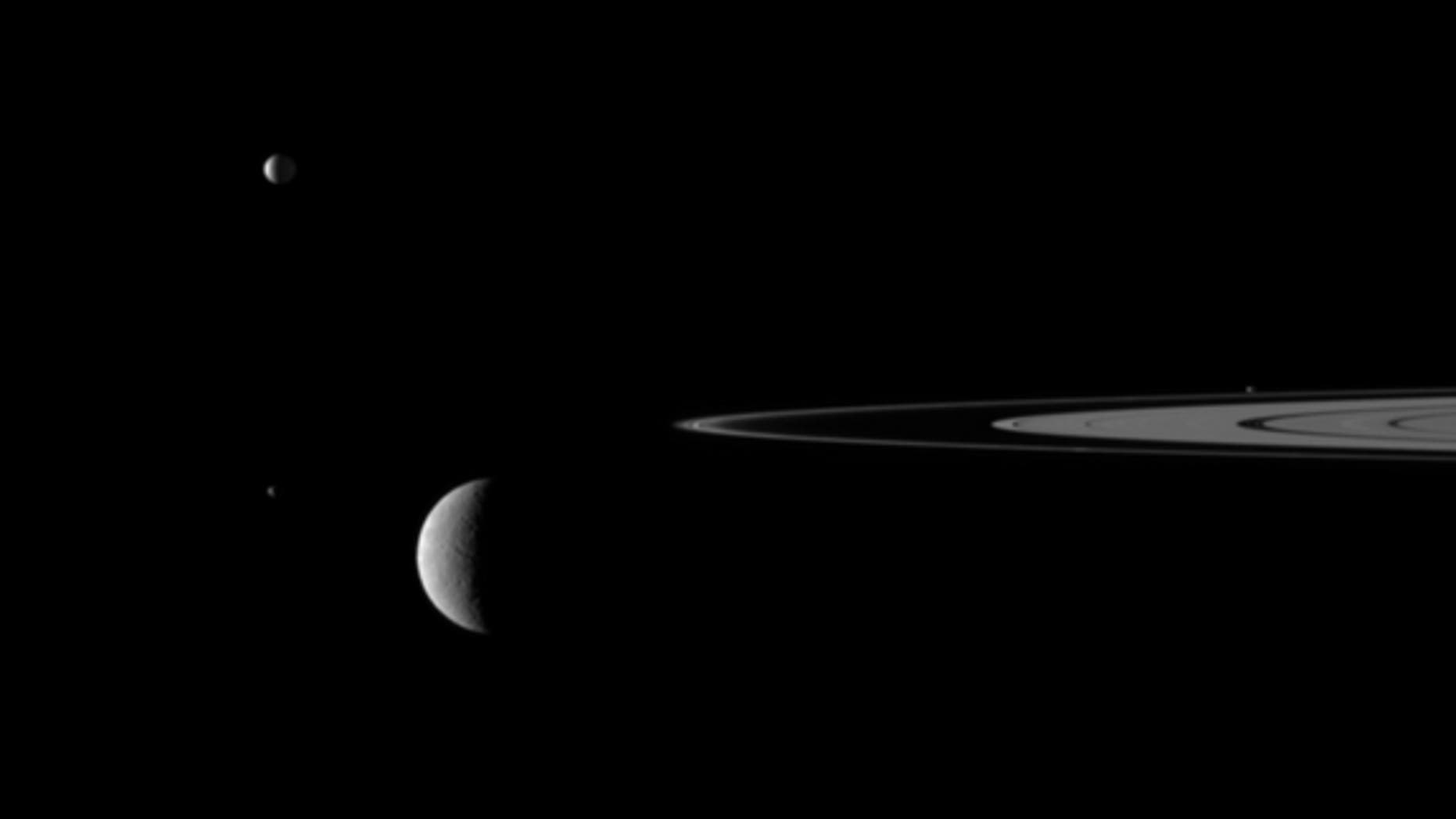 This still from the video "Outer Space" shows Saturn's rings and four of the giant planet's moons.