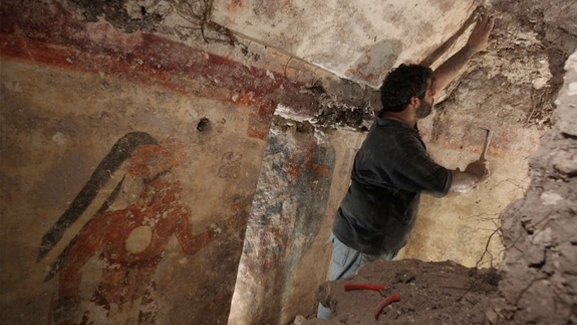 Archaeologist William Saturno of Boston University carefully uncovers art and writings left by the Maya some 1,200 years ago. The art and other symbols on the walls may have been records kept by a scribe, Saturno theorizes.